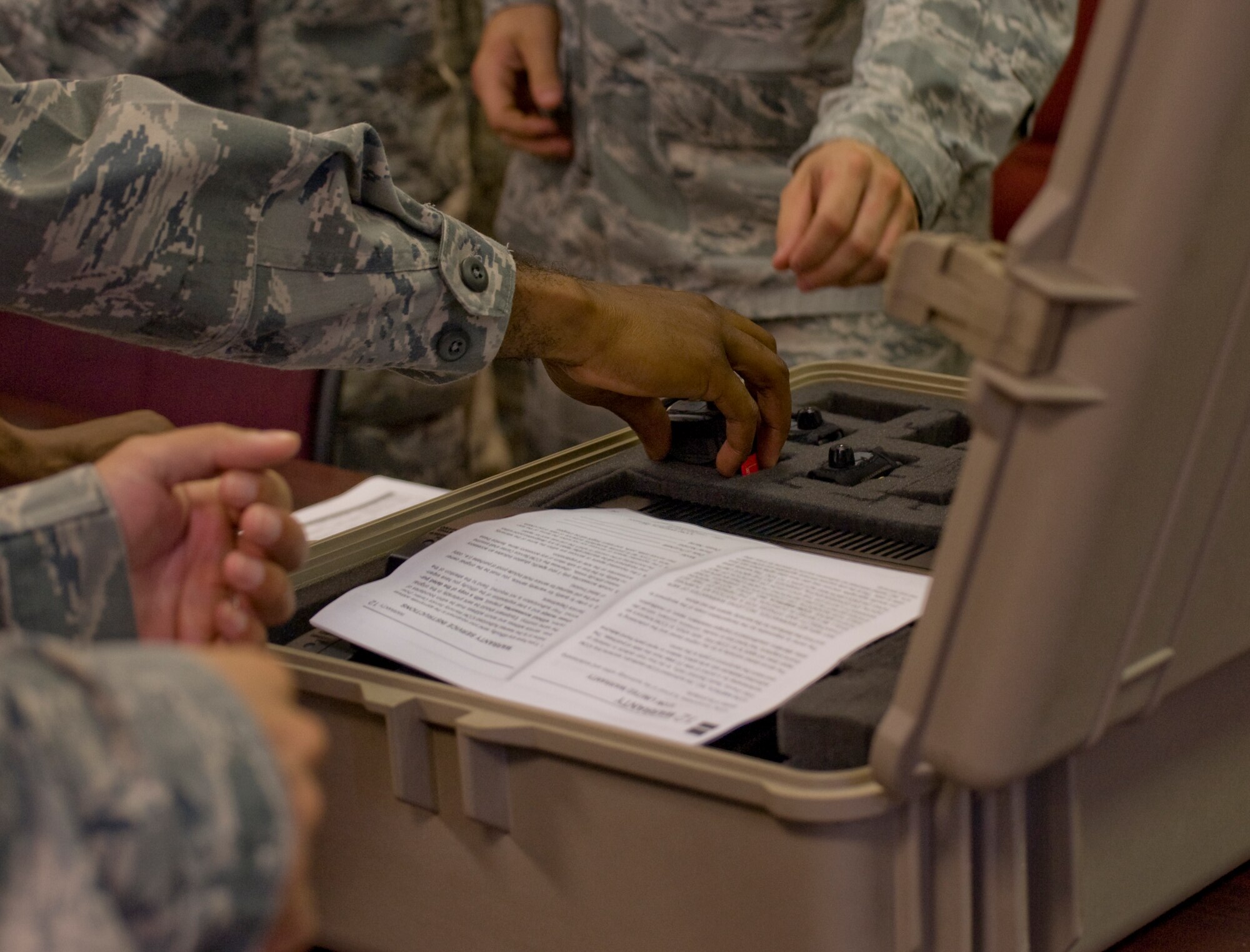 Hurlburt Airmen grab communication devices and itineraries during the pre-departure briefing at Hurlburt Field, Fla., Aug. 26, 2012. Hurlburt Field assets were being evacuated as Tropical Storm Isaac approaches the Gulf Coast region. (U.S. Air Force photo / Airman 1st Class Nigel Sandridge)