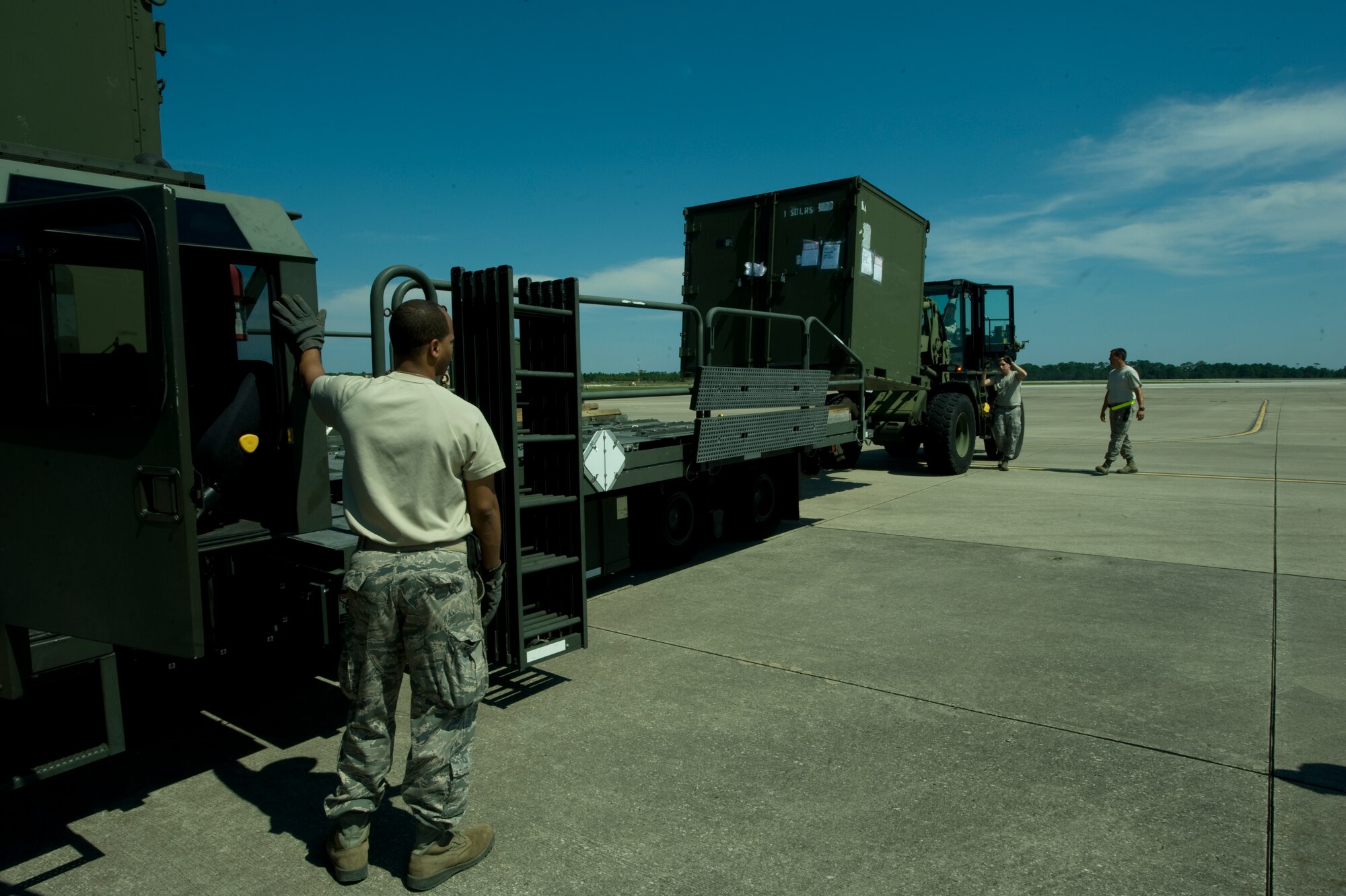 Staff Sgt. Glendelle Lisane, an aerial delivery supervisor of 1st Special Operations Logistics Readiness Squadron, supervises as Airmen use a forklift to load a flat bed on the flightline at Hurlburt Field, Fla., Aug. 26, 2012. Hurlburt Field assets were being evacuated as Tropical Storm Isaac approaches the Gulf Coast region. (U.S. Air Force photo / Airman 1st Class Nigel Sandridge)