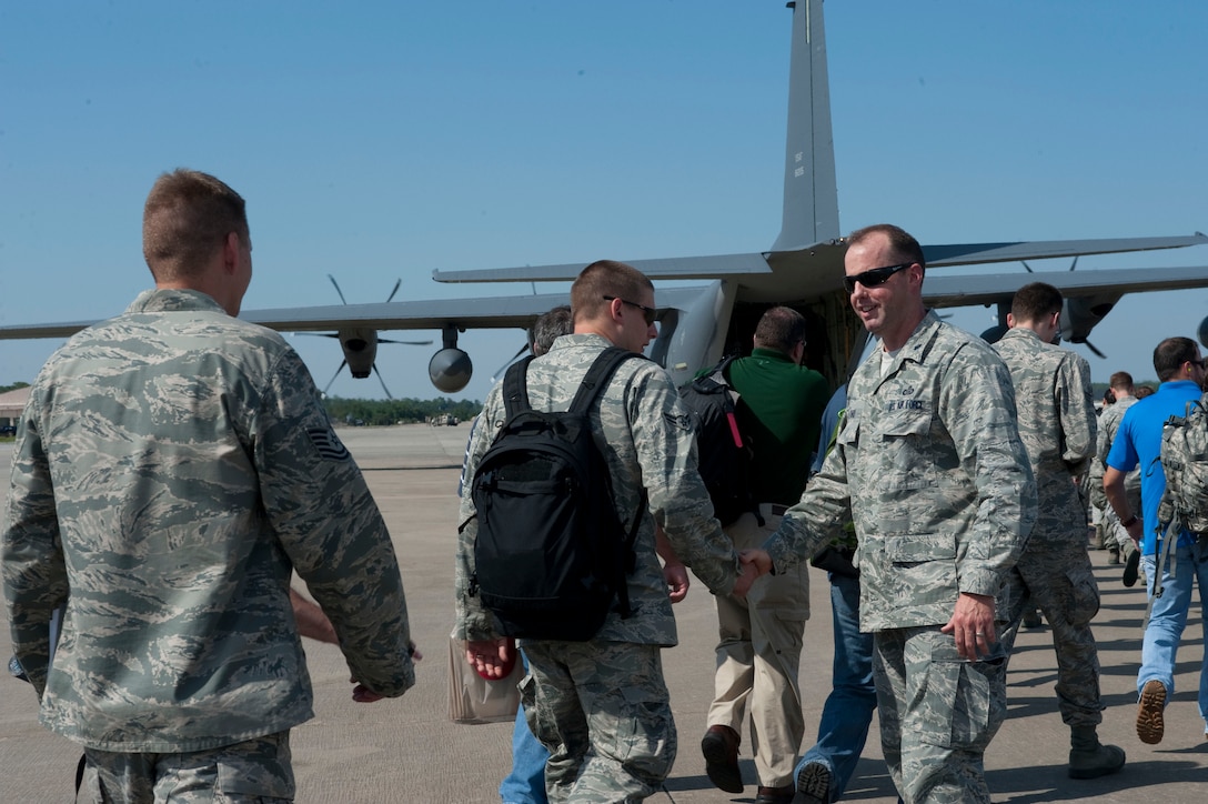U.S. Air Force Lt. Col. Bryan Collord, commander of 11th Intelligence Squadron, shakes hands with Airmen from his squadron as they depart for the flightline on Hurlburt Field, Fla., Aug. 26, 2012. Hurlburt Field assets were being evacuated as Tropical Storm Isaac approaches the Gulf Coast Region. (U.S. Air Force Photo/Airman 1st Class Hayden K. Hyatt)
