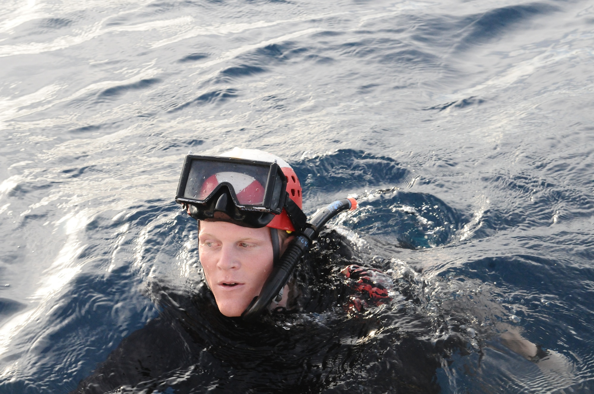 A search and rescue swimmer of Heicopter Sea Combat Squadron Two Five swims to his target during an exercise at Apra Harbor, Guam, June 14. HSC-25 servicemembers practice their skills to keep their alert posture. U.S. Air Force photo/Airman 1st Class Mariah Haddenham/Released)
