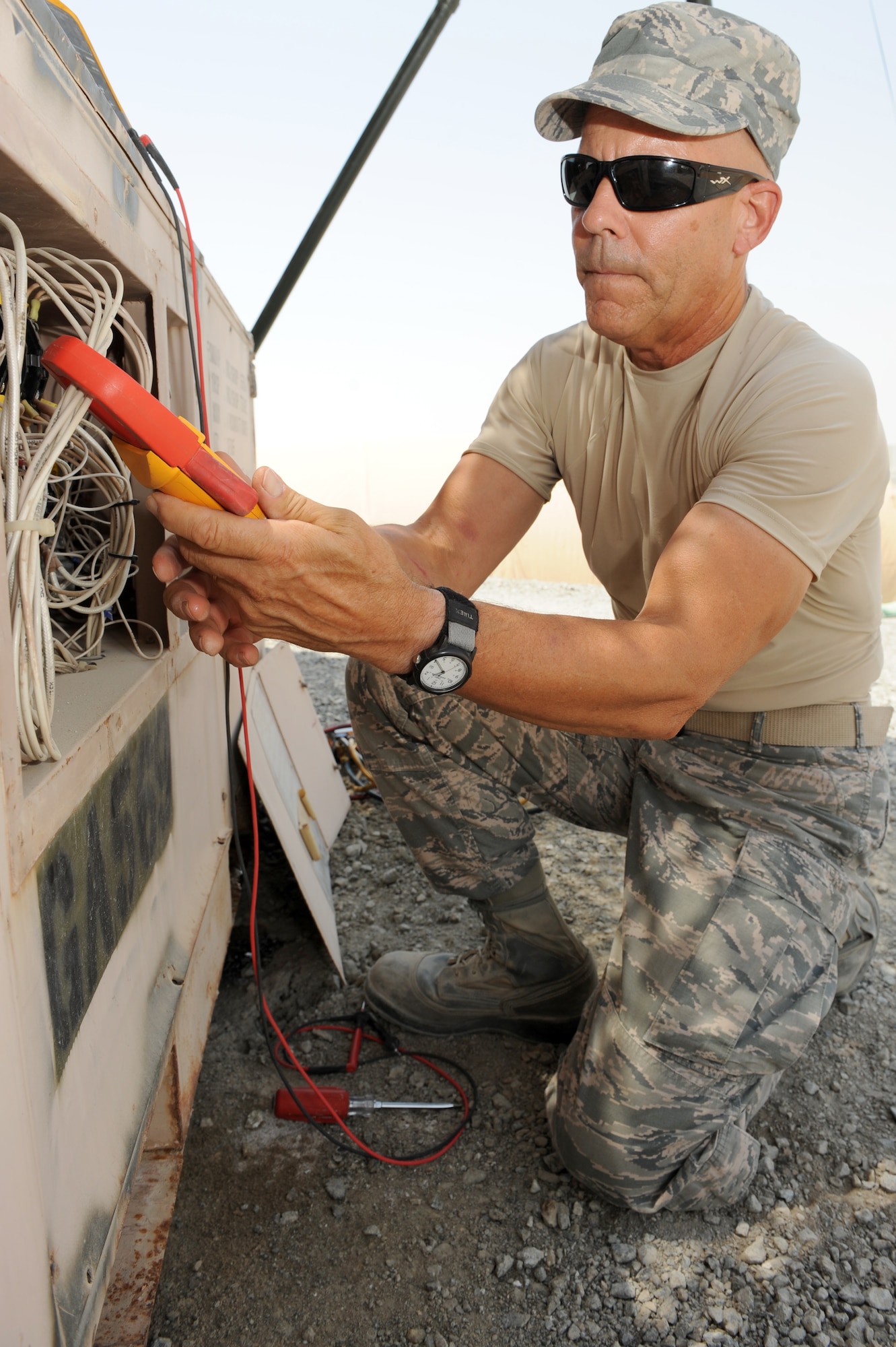 Master Sgt. John Anderson tests the amperage of an air conditioning unit Aug. 23, 2012. Anderson is the 727th Expeditionary Air Control Squadron Heating, Ventilation and air conditioning NCO in charge, and as a Moodus, Conn., native, is deployed to the 380th Air Expeditionary Wing from the Connecticut Air Guard. (U.S. Air Force photo/Master Sgt. Scott MacKay) 
