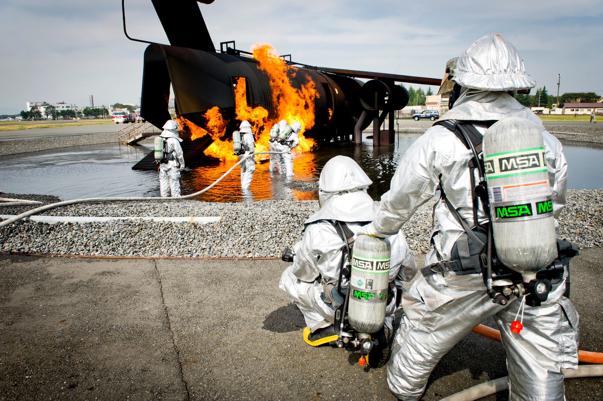 YOKOTA AIR BASE, Japan -- Firefighters from the 374th Civil Engineer Squadron extinguish a fire on an simulated aircraft, Oct. 11, 2011, during a live-fire training exercise at Yokota Air Base, Japan. The firefighters participate in this type of training to keep their skills sharp and always stay ready for fire emergencies. (U.S. Air Force photo by Staff Sgt. Stacy Moless)