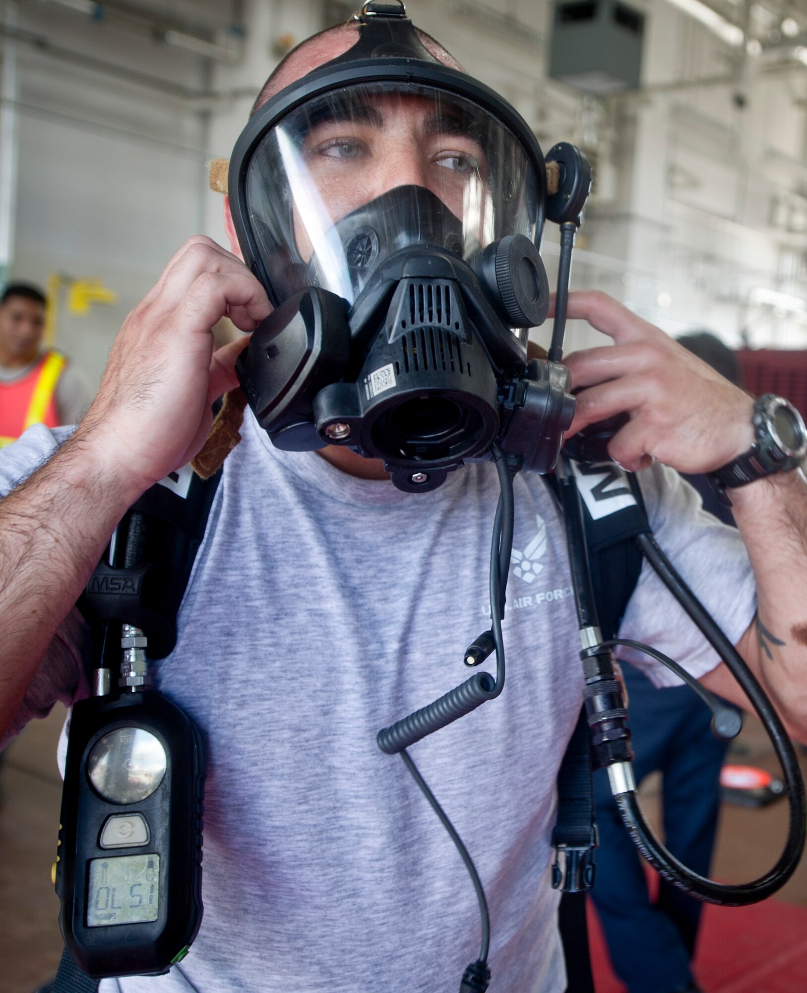 YOKOTA AIR BASE, Japan -- Senior Airman Destry Swadowski, 374th Civil Engineer Squadron chemical, biological, and nuclear warfare specialist, removes his self-contained breathing apperatus at Yokota Air Base, Japan, July 30, 2012.  Swadowski trained with the firefighters during a hazardous materials training course exercise. This course, while mostly attended by firefighters, is also open to Airmen in career fields who would be called on-scene during a real disaster response. (U.S. Air Force photo by Staff Sgt. Stacy Moless)