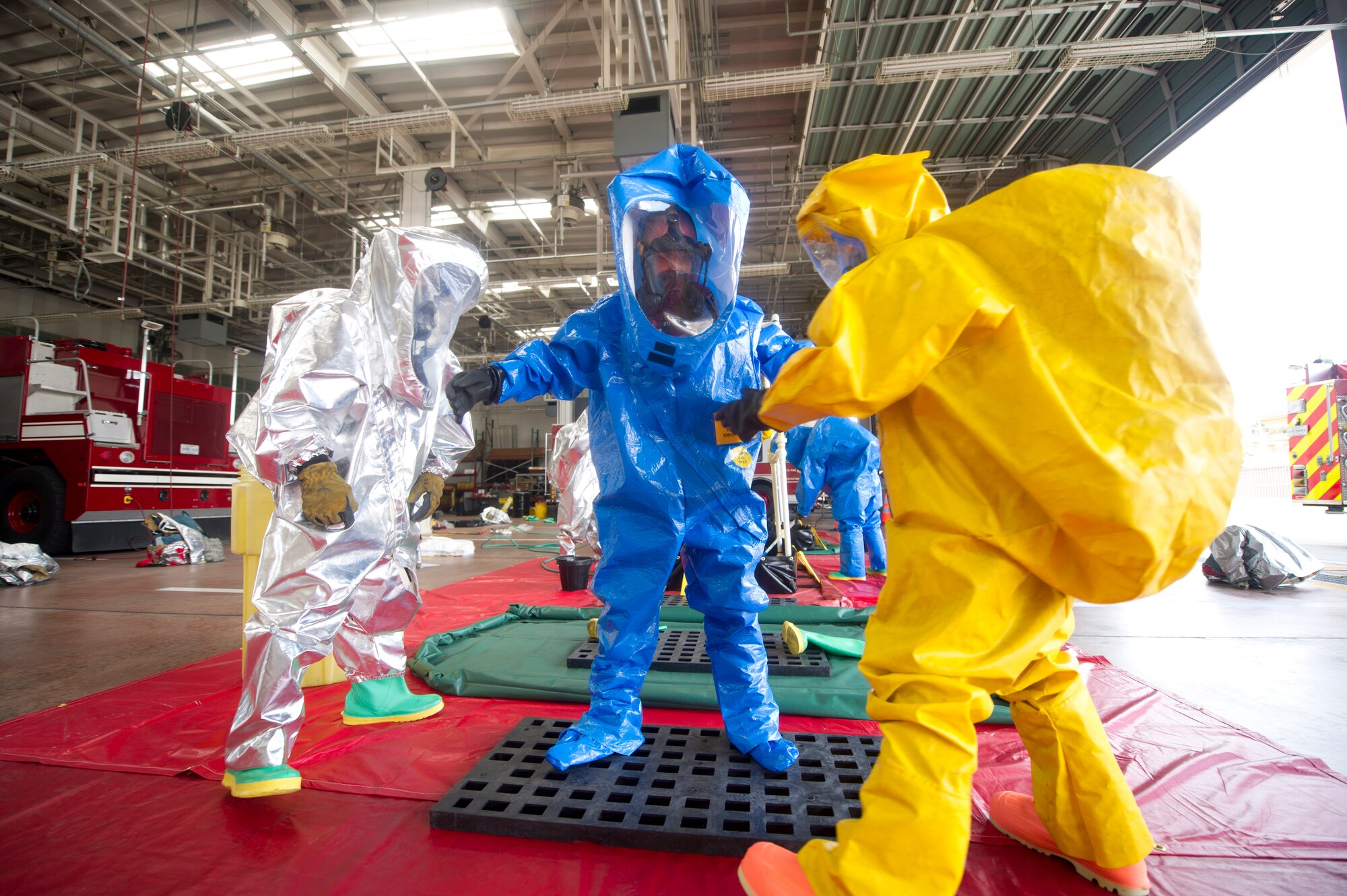 YOKOTA AIR BASE, Japan -- Firefighters from the 374th Civil Engineer Squadron simulate decontamination procedures during a hazardous materials training course at Yokota Air Base, Japan, July 30, 2012. The training experience is valuable for the firefighters because it tests their knowledge and ability to identify and react to HAZMAT agents. (U.S. Air Force photo by Staff Sgt. Stacy Moless)