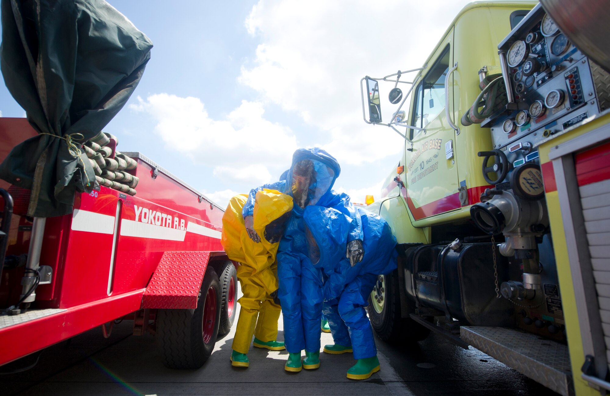 YOKOTA AIR BASE, Japan -- Firefighters from the 374th Civil Engineer Squadron carry a simulated victim during a hazardous materials training course at Yokota Air Base, Japan, July 30, 2012. During the training, firefighters identify and react to HAZMAT agents while taking care of victims by decontaminating and transporting them to safety. (U.S. Air Force photo by Staff Sgt. Stacy Moless)