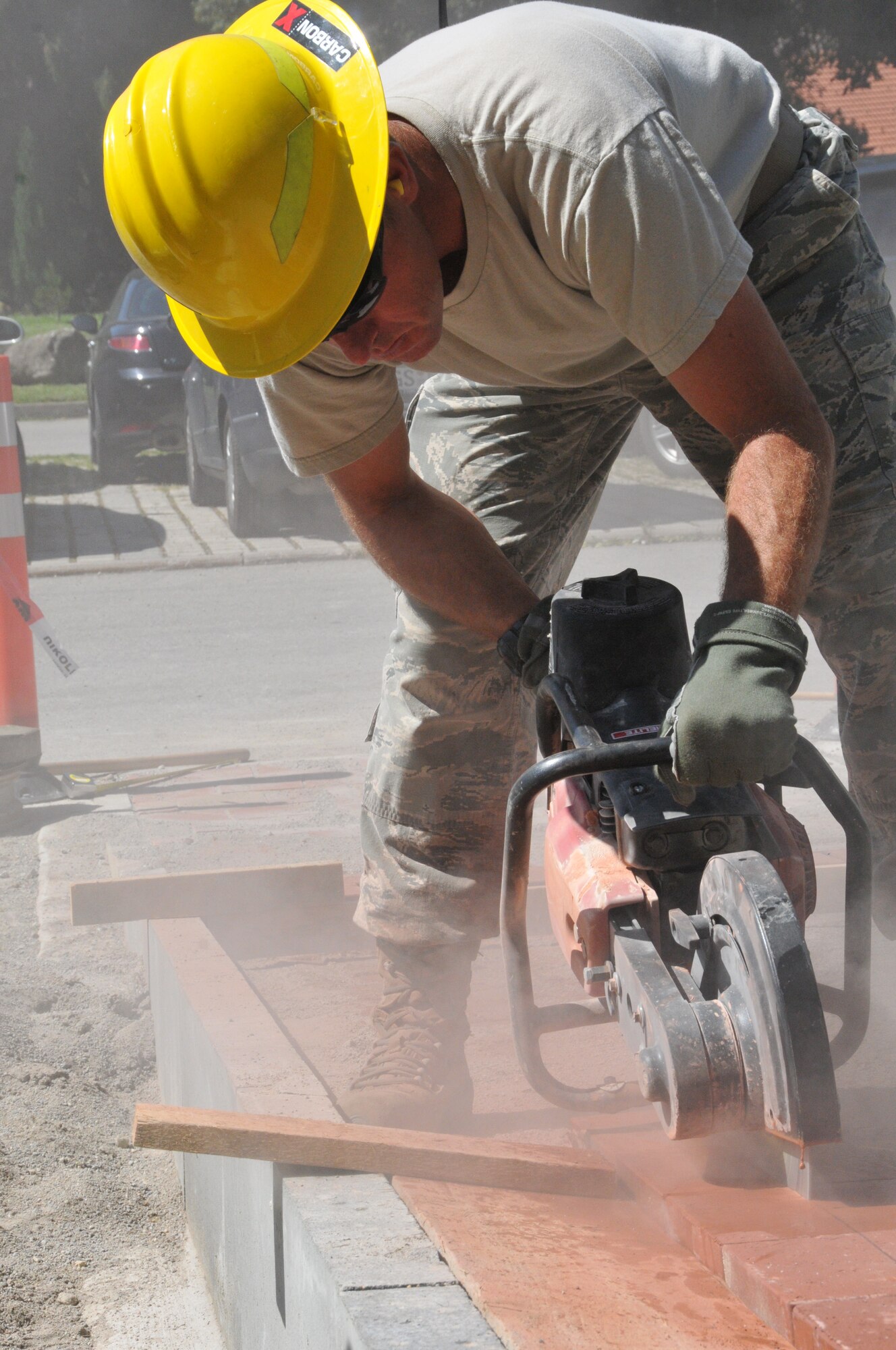 Wyoming Air National Guard’s Master Sgt. Jesse Johnson, 153rd Civil Engineer Squadron, cuts pavers with a K-12 saw for a new walk way at the NATO School Aug. 20, 2012, Oberammergau, Germany.  Airmen from the 153rd CES are putting their skills to work as they conduct their annual training. (U.S. Air Force photo by Staff Sgt. Natalie Stanley)