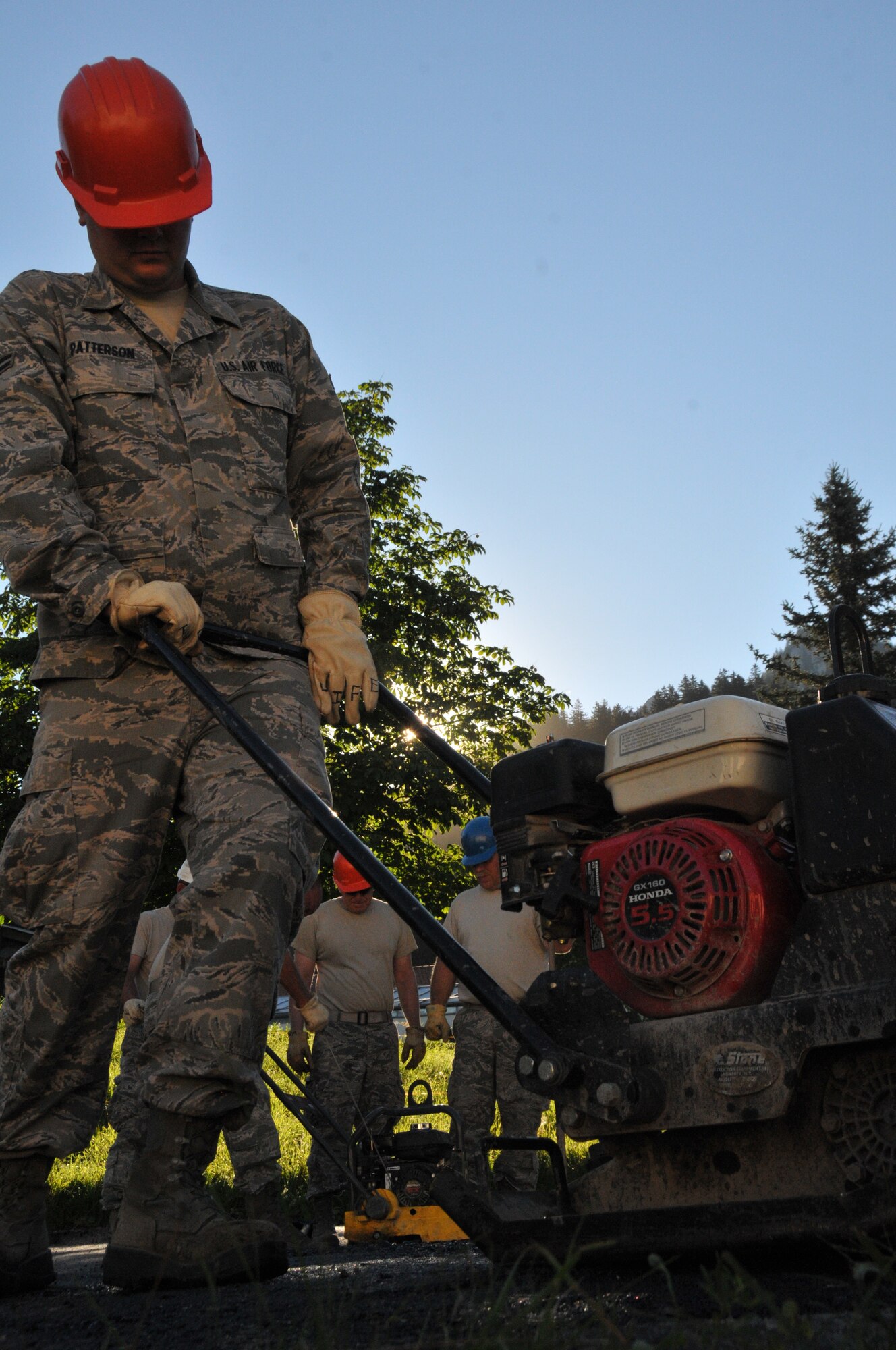 Wyoming Air National Guard’s Senior Airman Will Patterson, 153rd Civil Engineer Squadron, operates a plate tamper to pack down freshly laid asphalt at the NATO School Aug. 20, 2012, Oberammergau, Germany.  Airmen from the 153rd CES are putting their skills to work as they conduct their annual training. (U.S. Air Force photo by Staff Sgt. Natalie Stanley)