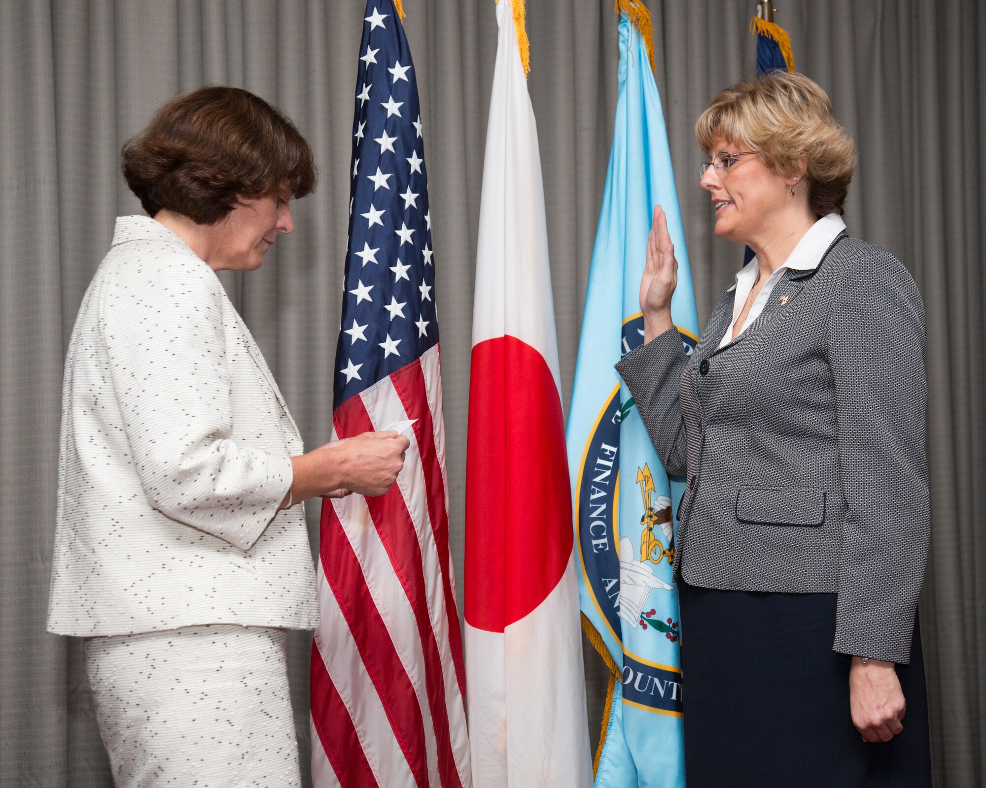 YOKOTA AIR BASE, Japan -- Jana Haynie, right, incoming director of the U.S. Defense Finance and Accounting Service, Japan, recites an oath to Teresa McKay, DFAS director, during an assumption of leadership ceremony at Yokota Air Base, Japan, Aug. 24, 2012. Haynie was the director of finance at DFAS Columbus. (U.S. Air Force photo by Osakabe Yasuo)
