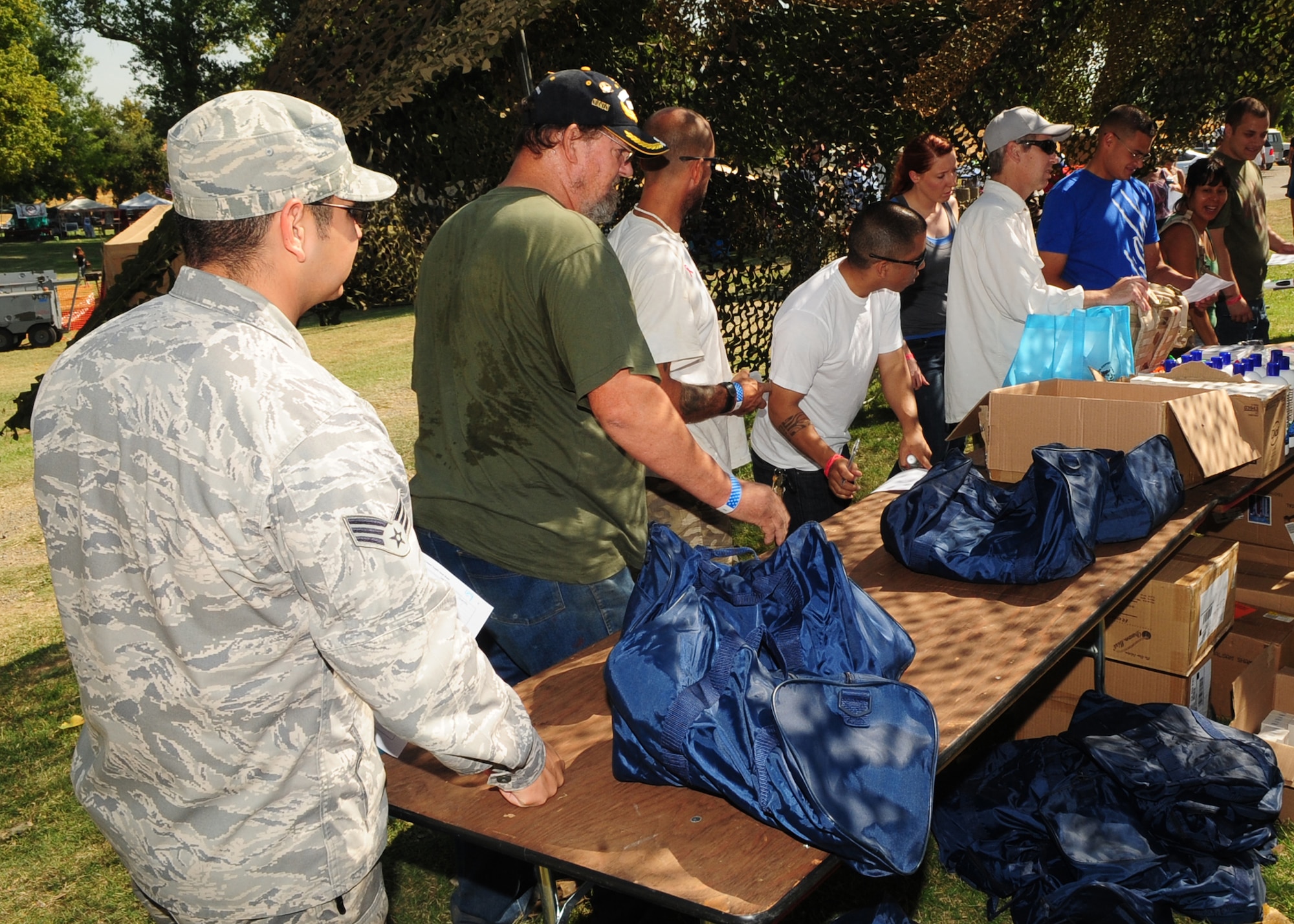 Veterans line up to receive clothing, sleeping bags and backpacks during the 2012 Veteran's Stand Down at River Bottoms Park in Marysville, Calif., August 24, 2012. Each veteran was escorted by a Beale Air Force Base, Calif., Airman. (U.S. Air Force photo by Senior Airman Shawn Nickel)