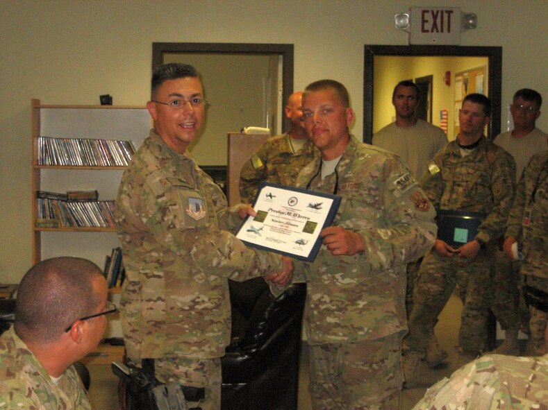 Senior Airman Preston Warren, right, receives a promotion certificate from Lt. Col. Rudy Cardona at Bagram Airfield, Afghanistan. Warren is a member of the 188th Fighter Wing, which has approximately 375 Airmen currently deployed to Afghanistan in support of Operation Enduring Freedom. (Courtesy photo)