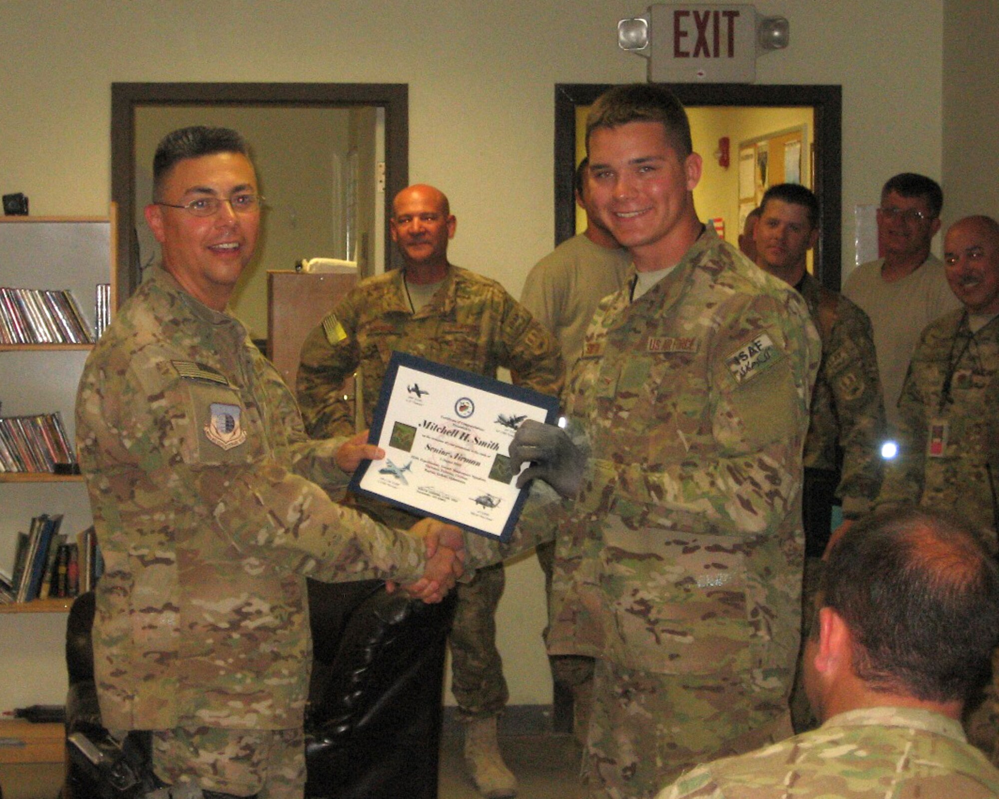 Senior Airman Mitchell Smith, right, receives a promotion certificate from Lt. Col. Rudy Cardona at Bagram Airfield, Afghanistan. Smith is a member of the 188th Fighter Wing, which has approximately 375 Airmen currently deployed to Afghanistan in support of Operation Enduring Freedom. (Courtesy photo)
