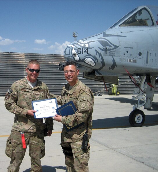 Master Sgt. Paul Denton, left, receives a promotion certificate from Lt. Col. Rudy Cardona while deployed to Bagram Airfield, Afghanistan. Denton is one of approximately 375 Airmen with the 188th Fighter Wing currently deployed to Afghanistan in support of Operation Enduring Freedom. (Courtesy photo)