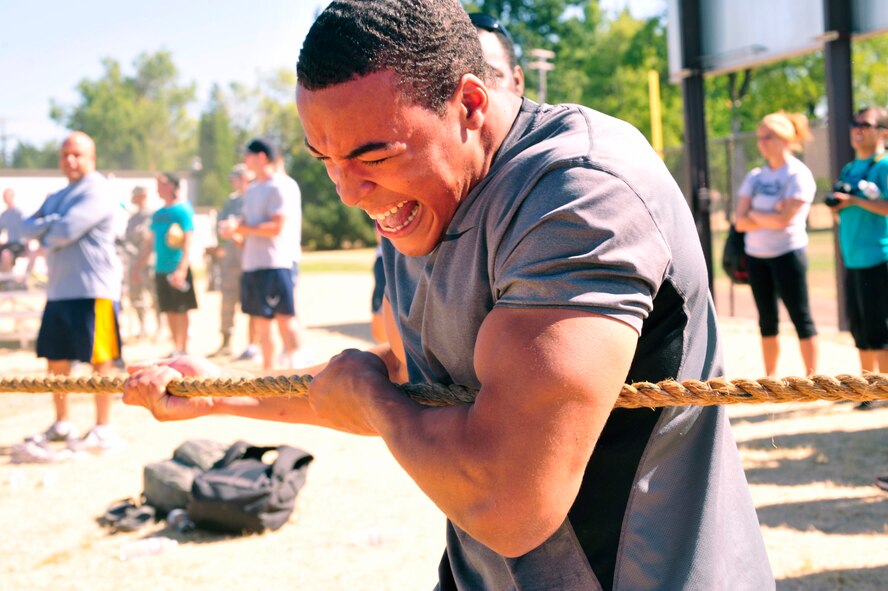 Airman 1st Class Christian Hill, 62nd Operations Support Squadron, uses all his strength to pull on a rope during the tug-of-war competition Aug. 24, 2012, at Joint Base Lewis-McChord, Wash. The 62nd OSS took second place in the competition. (U.S. Air Force photo/Staff Sgt. Frances Kriss)