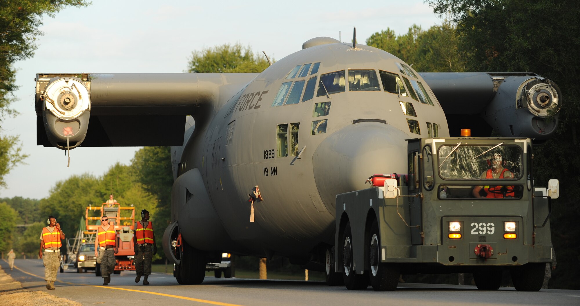 Members of the 19th Equipment Maintenance Squadron tow a C-130E down Vandenberg Boulevard, Aug. 26, 2012, in Jacksonville, Ark. The C-130 will be placed at the Little Rock Air Force Base - City of Jacksonville Joint Education Center as the new static display. (U.S. Air Force photo by Staff Sgt. Jessica Condit)