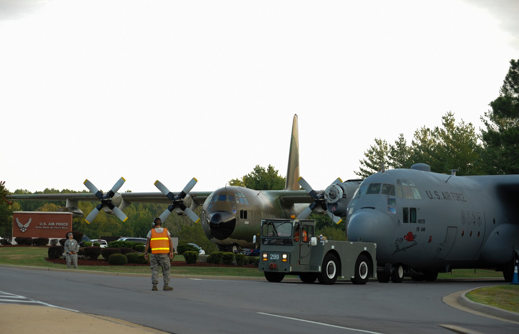 Members of the 19th Equipment Maintenance Squadron tow a C-130 through the Marshall Road gate, Aug. 26, 2012, in Jacksonville, Ark. The entire move required two days of support from the 19th EMS and the 19th Civil Engineer Squadron. (U.S. Air Force photo by Staff Sgt. Jessica Condit) 