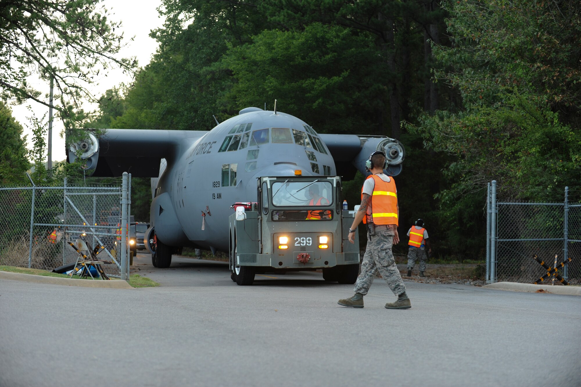 Members of the 19th Equipment Maintenance Squadron prepare to tow the C-130E from the Marshall Road gate to the Little Rock Air Force Base - City of Jacksonville Joint Education Center, Aug. 26, 2012, in Jacksonville, Ark. The C-130 will be placed as the new static display for the education center. (U.S. Air Force photo by Staff Sgt. Jessica Condit) 
