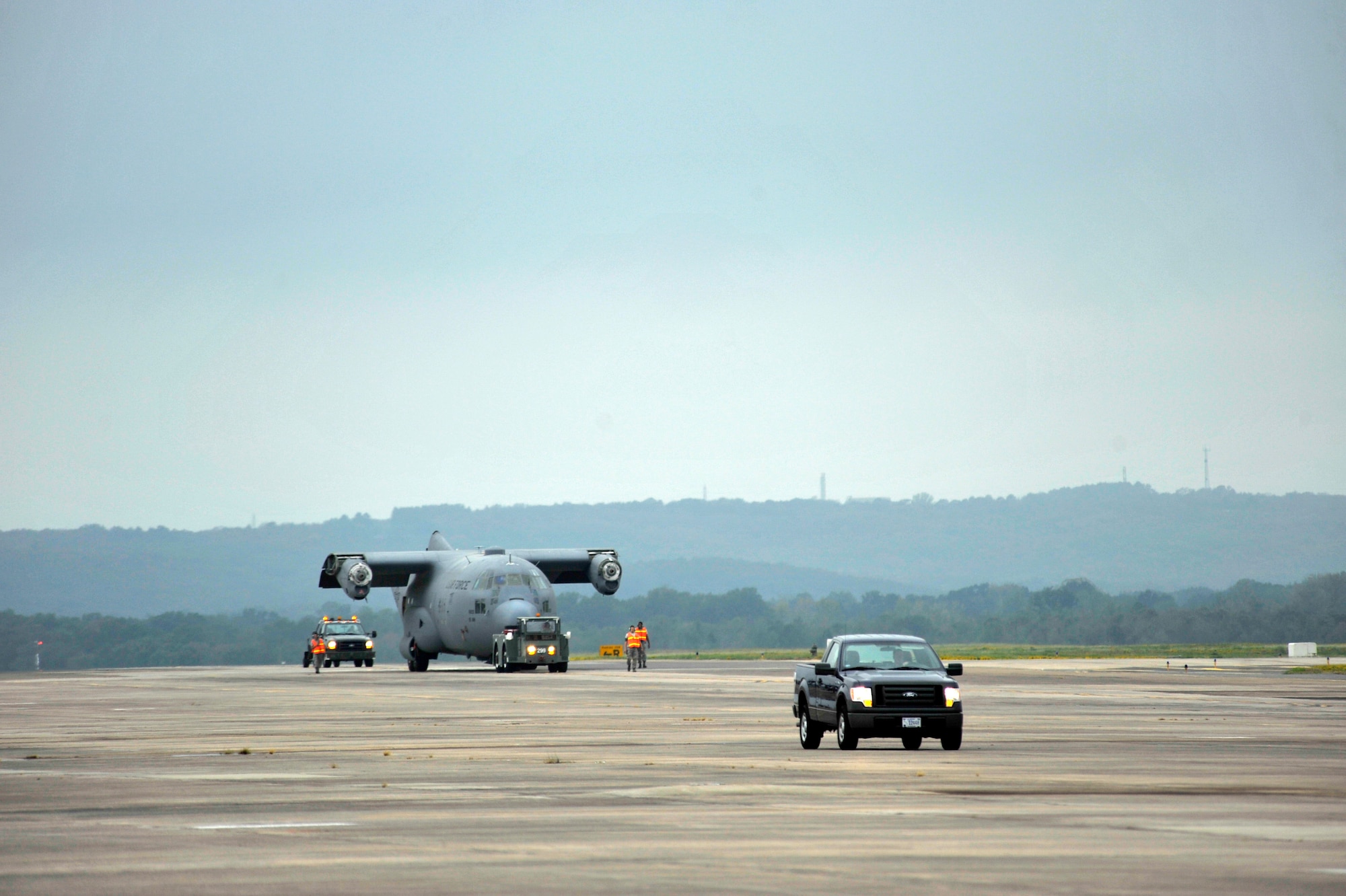 Members of the 19th Equipment Maintenance Squadron maintenance flight tow a C-130E on the flight line Aug. 25, 2012, at Little Rock Air Force Base, Ark. All C-130E models from the base are being retired. (U.S. Air Force photo by Airman 1st Class Rusty Frank)