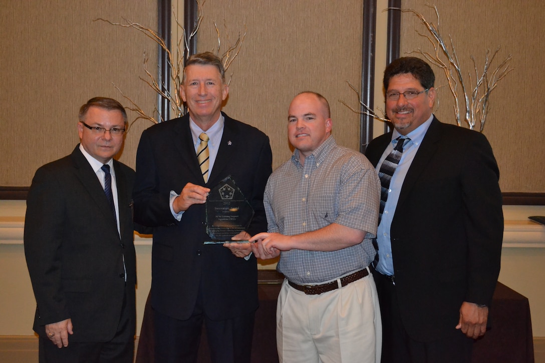 Left to right: Russ G. Culbert, U.S. Federal Government Market Director, Polycom, Inc. & Vice-President Corporate Sector, Federal Government Distance Learning Association; Dr. C. Brent Metcalf, 367th Training Support Squadron, Director of Operations; Master Sergeant Donald S. Bozeman, 367th Training Support Squadron, Immersive Technology Flight Chief; Alex J. Autry, Jr., Chief, Instructional Quality, Air Technology Network, Department of the Air Force & President, Federal Government Distance Learning Association. Mr. Culbert and Mr. Autry of the Federal Government Distant Learning Association (FGDLA) at Hill AFB present Dr. Metcalf and MSgt Bozeman representing the 367th Training Squadron Hill AFB , a detachment of the Sheppard AFB 782 Training Group, with the award for innovation on August 15. (Photo courtesy U.S. Air Force)