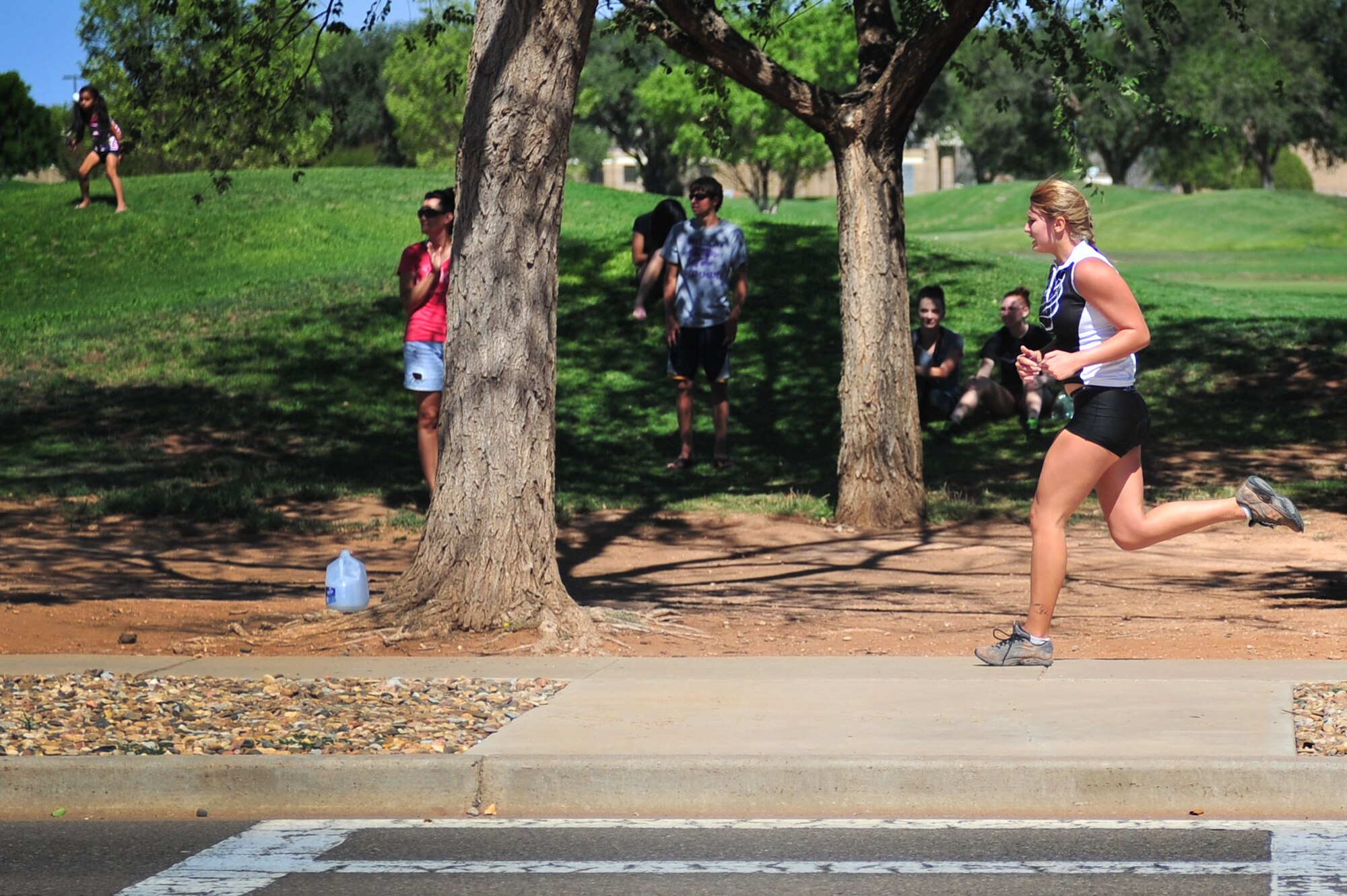 A competitor sprints to the finish during a mini triathlon at Cannon Air Force Base, N.M., Aug. 25, 2012.  This fitness challenge included a 500-meter lap swim, 8.5-mile bike ride and a 3.2-mile run.  (U.S. Air Force photo/Airman 1st Class Xavier Lockely)