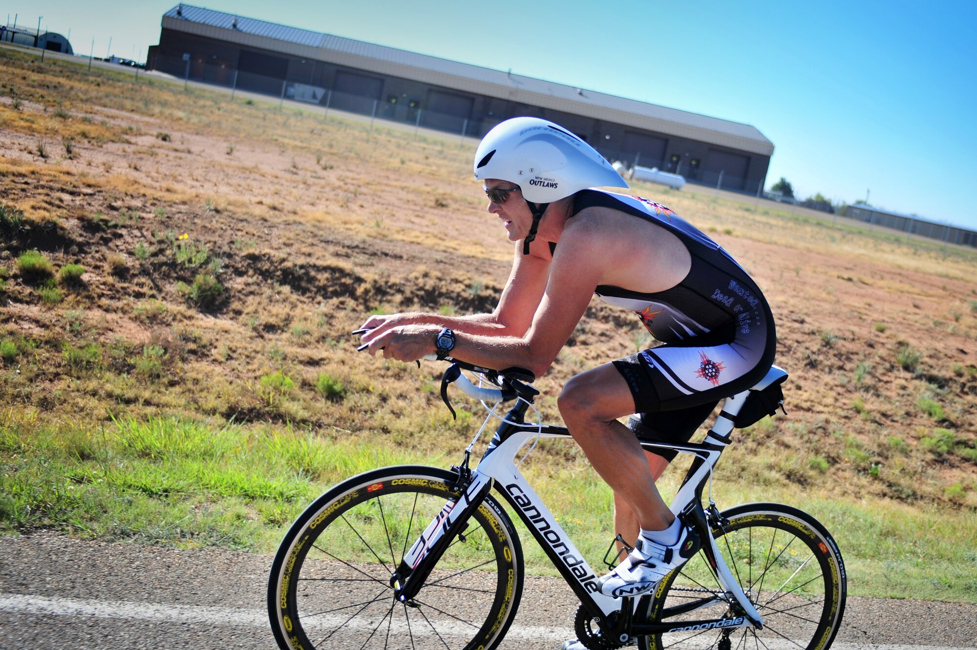 A cyclist competes in a mini triathlon at Cannon Air Force Base, N.M., Aug. 25, 2012.  This fitness challenge included a 500-meter lap swim, 8.5-mile bike ride and a 3.2-mile run. (U.S. Air Force photo/Airman 1st Class Xavier Lockely)