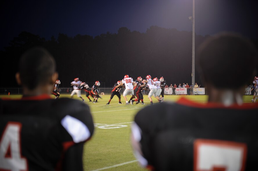 Players from the Lanier County High School Bulldogs watch as their teammates attempt to make a first down during a football game at Roquemore Field in Lakeland, Ga., Aug. 24, 2012. The Bulldogs defeated the Atkinson County High School Rebels with a final score of 19-8. (U.S. Air Force photo by Senior Airman Douglas Ellis/Released)
