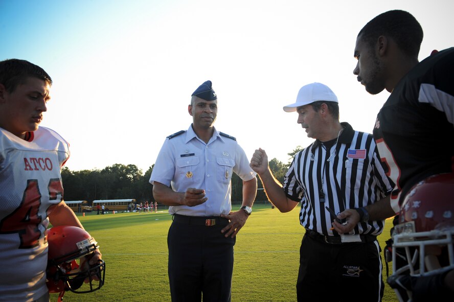 U.S. Air Force Col. Edward Ford, 23d Mission Support Group commander, prepares to toss a coin at Roquemore Field in Lakeland, Ga., Aug. 24, 2012. The Atkinson County High School Rebels won the toss and elected to kick during the initial kickoff. (U.S. Air Force photo by Senior Airman Douglas Ellis/Released)
