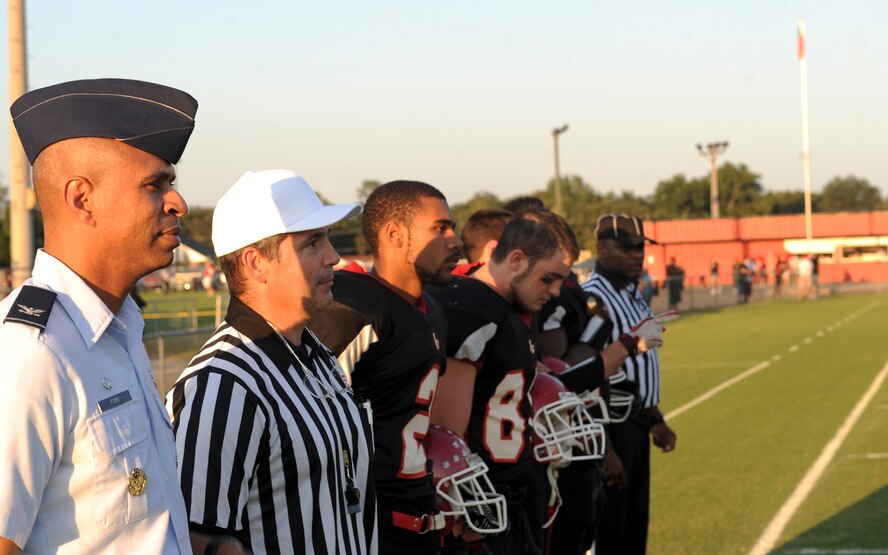 U.S. Air Force Col. Edward Ford, 23d Mission Support Group commander, stands beside referees and team captains from the Lanier County High School Bulldogs at Roquemore Field in Lakeland, Ga., Aug. 24, 2012. Ford flipped the coin to start the game in recognition of Military Appreciation Day. (U.S. Air Force photo by Senior Airman Douglas Ellis/Released)
