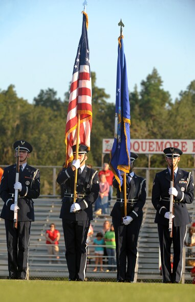 U.S. Air Force Honor Guardsmen from Moody Air Force Base, Ga., present the colors before the start of a football game at Roquemore Field in Lakeland, Ga., Aug. 24, 2012. The game was between the Lanier County High School Bulldogs and the Atkinson County High School Rebels. (U.S. Air Force photo by Senior Airman Douglas Ellis/Released)
