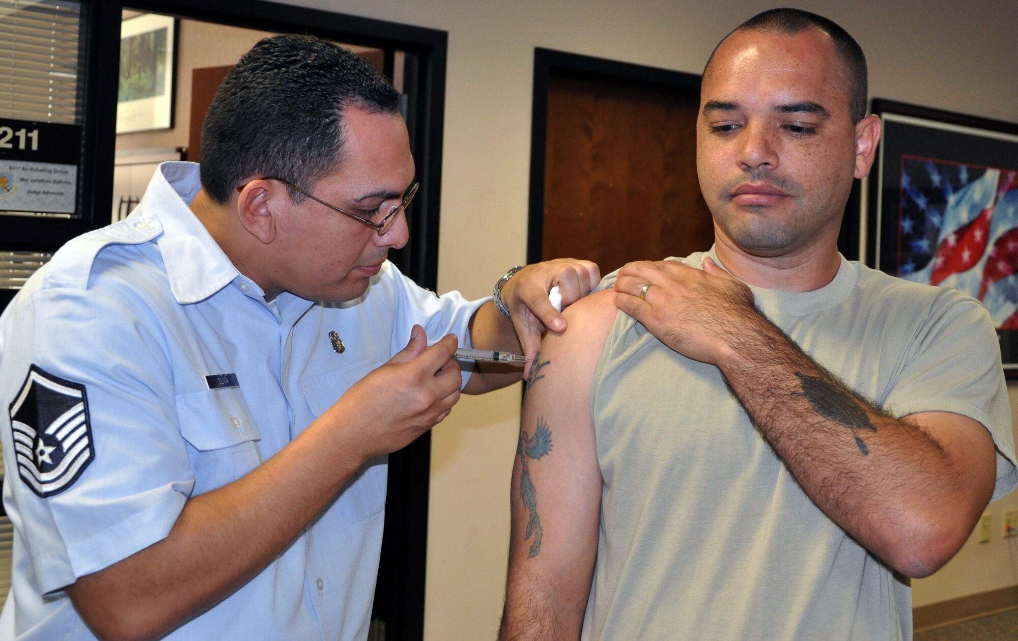 Master Sgt. Renato Oliva, a medical technician assigned to the 931st Aeromedical Squadron, uses a syringe to administer a typhoid vaccination shot to Senior Master Sgt. Willie Tucker, 1st Sergeant for the 931st Aircraft Maintenance Squadron, at McConnell Air Force Base, Kan., Aug. 27, 2012.  Air Force Reservist are required to stay current on several different types of vaccinations in order to maintain a constant state of readiness.  (U.S. Air Force photo by 1st Lt. Zach Anderson)