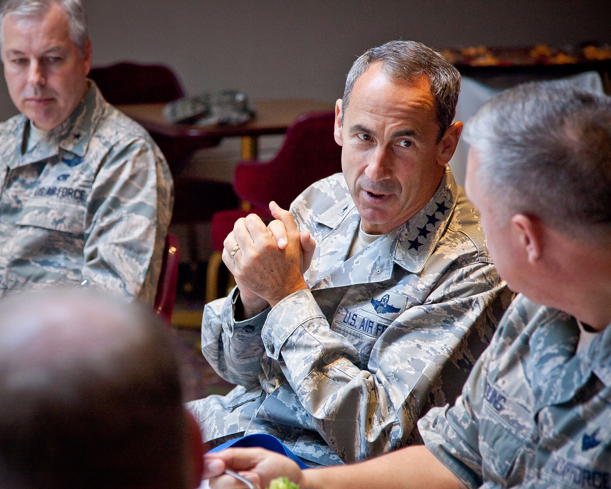 Gen. Raymond E. Johns, Commander, Air Mobility Command, speaks with Col. Darrell G. Young, Commander of the 934th Airlift Wing, at a luncheon as part of a tour to visit all of the reserve and guard units in the country, talking to Airmen and leadership to understand what issues are important to the Air Force at a local level.  (U.S. Air Force Photo/Shannon McKay)