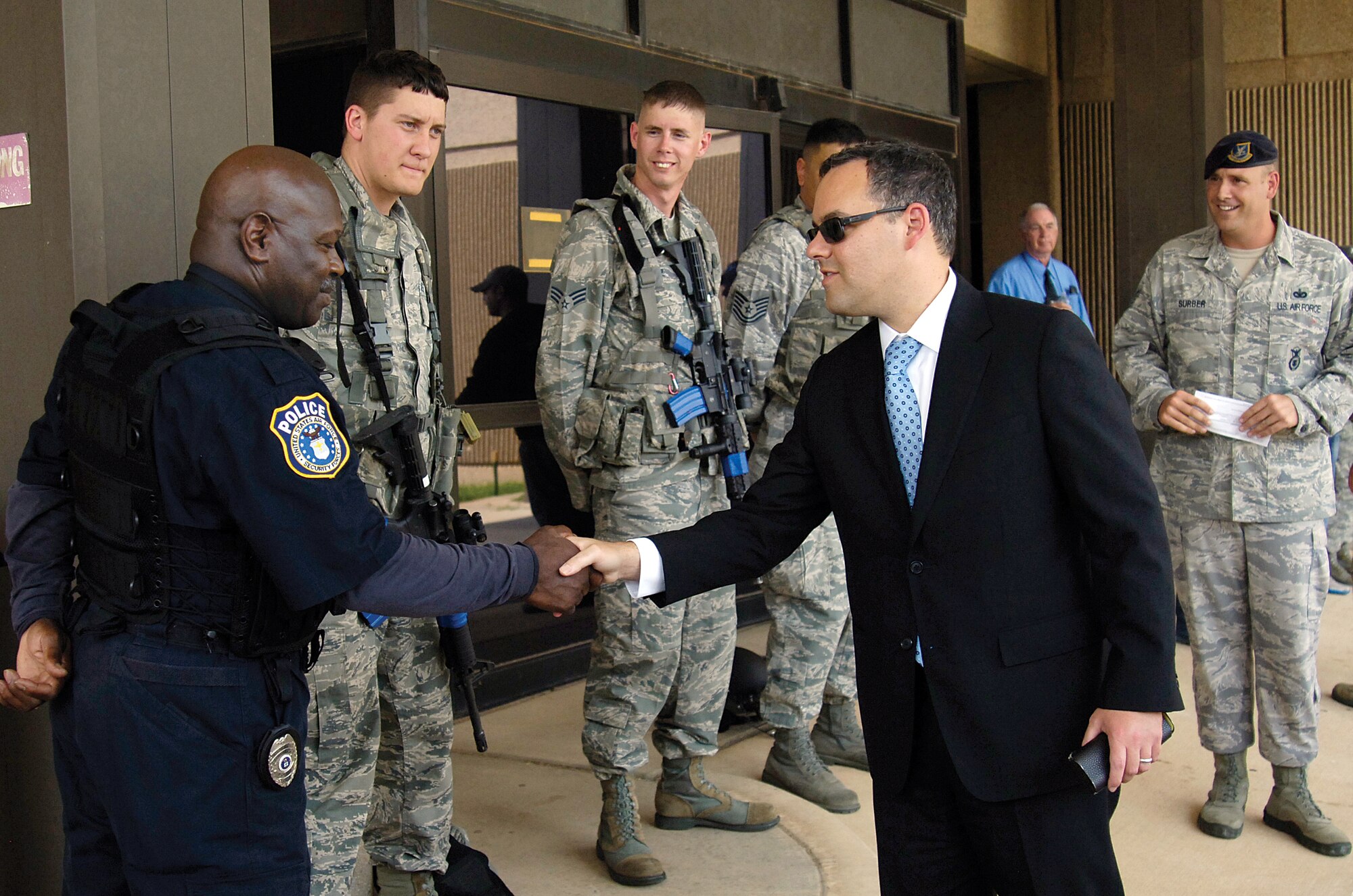 Daniel Ginsberg, assistant secretary of the Air Force for Manpower and Reserve Affairs, Washington, D.C., greets Tinker police officer Venoy Rodgers and other 72nd Security Forces Squadron defenders. During the assistant secretary’s Aug. 16 Tinker visit, he traveled to various organizations across base, thanking personnel for their service.  