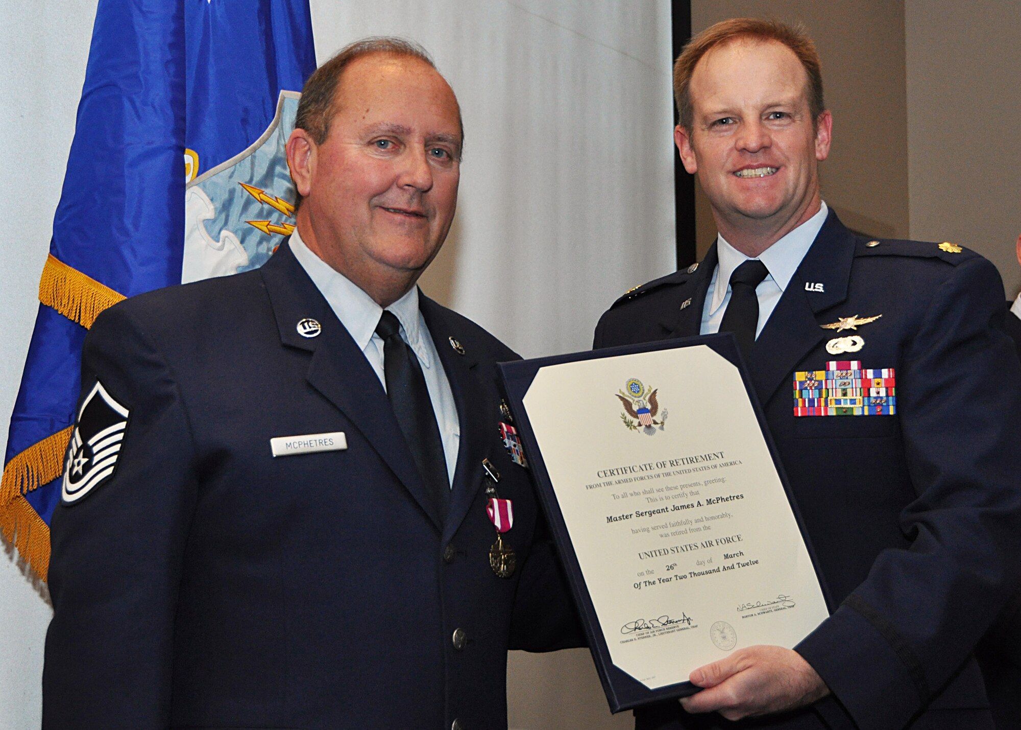 Master Sgt. Jim McPhetres receives his retirement certificate from Major Lonnie Sell, commander, 944th Force Support Squadron, March 4, 2012. McPhetres retired after more than 36 years uniformed service. (Courtesy Photo)
