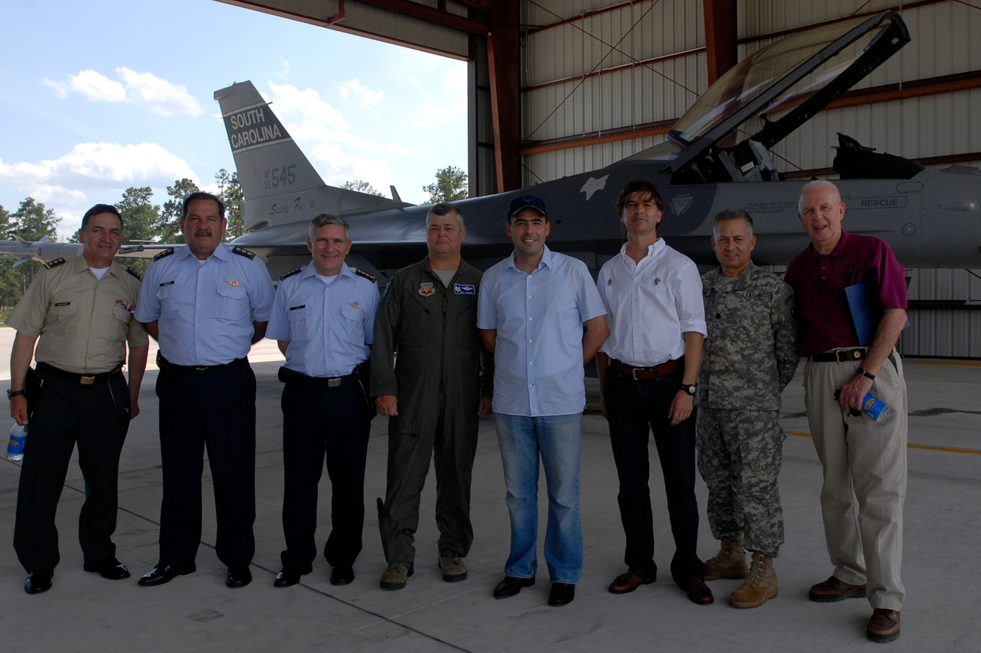 Col. Mike Hudson, 169th Fighter Wing Commander at McEntire Joint National Guard Base, S.C., and members of a Colombian delegation pose for a photo during a tour of base facilities July 24, 2012. The visit occurred one day after announcing the State Partnership between South Carolina and the Republic of Colombia. The historic bilateral partnership will promote mutual capabilities, national security objectives and long term stability.
(SCANG photo by Tech. Sgt. Caycee Watson)
