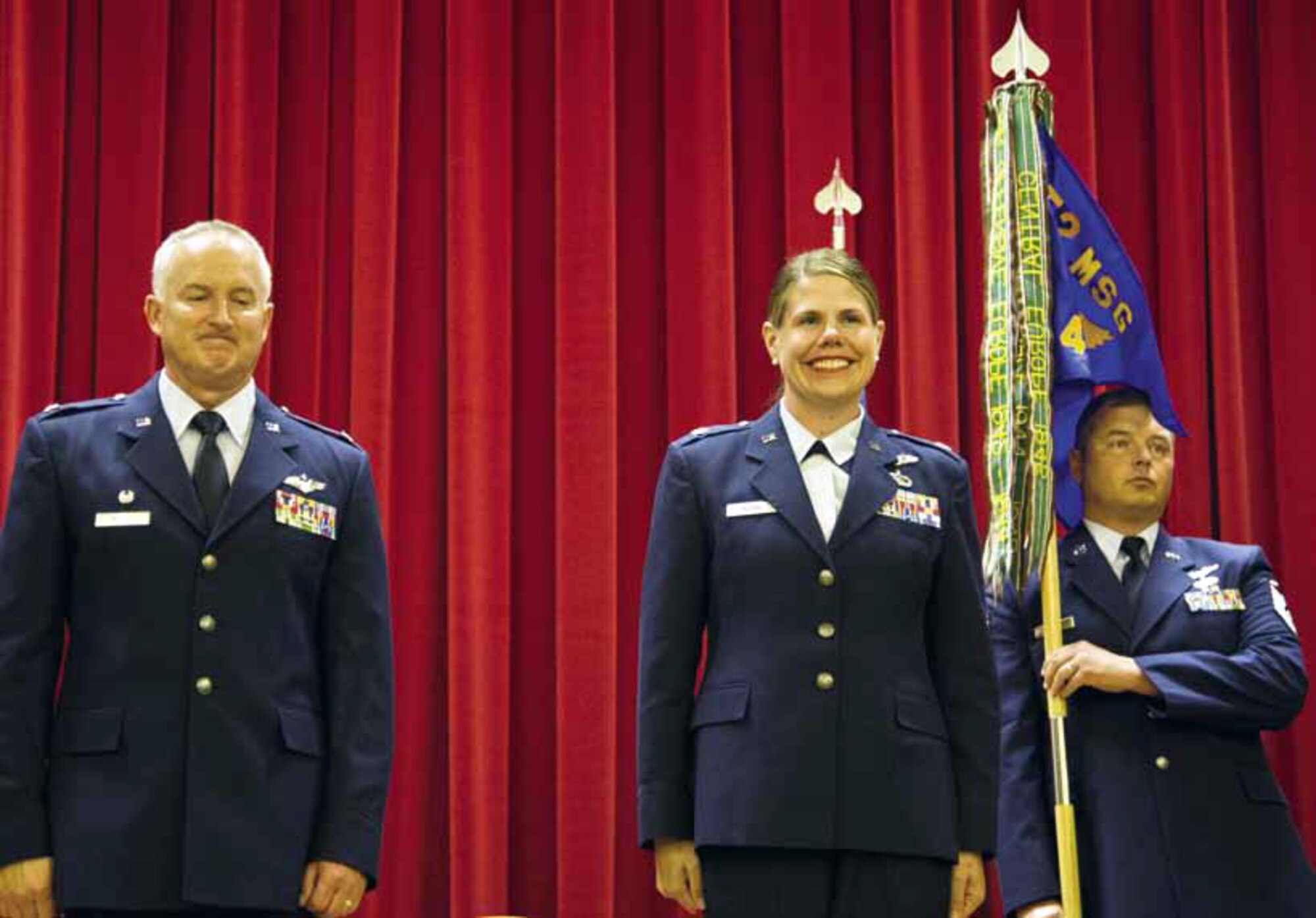 Major Beth Horine, 4th Combat Camera Squadron incoming commander, prepares
to take command of the unit from Colonel Timothy McCoy, 452nd Mission Support Group commander, August 4, during an assumption of command ceremony in the Cultural Resource Center. Master Sgt. Randall Hopp, 4th Combat Camera Squadron, holds the guidon which symbolizes the transfer of authority from the old to the new commander. (U.S. Air Force photo by Staff Sgt. Jared Becker)