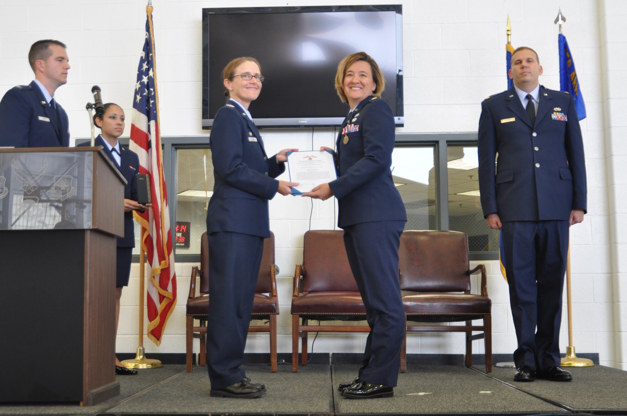 Col. Maureen Banavige, 459th Maintenance Group commander, awards Maj. Wendy Duffy, 459th Maintenance Squadron commander, the Meritorious Service Award moments before Duffy relinquishes command to Maj. Keith McCray, 459 MXS officer, in Hangar 11, Aug. 25, 2012. McCray has been a full-time Active Reserve Technician with the 459th MXS for the past three years. (U.S. Air Force photo/Senior Airman Amber Russell)