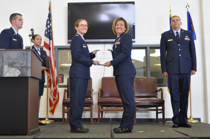 Col. Maureen Banavige, 459th Maintenance Group commander, awards Maj. Wendy Duffy, 459th Maintenance Squadron commander, the Meritorious Service Award moments before Duffy relinquishes command to Maj. Keith McCray, 459 MXS officer, in Hangar 11, Aug. 25, 2012. McCray has been a full-time Active Reserve Technician with the 459th MXS for the past three years. (U.S. Air Force photo/Senior Airman Amber Russell)