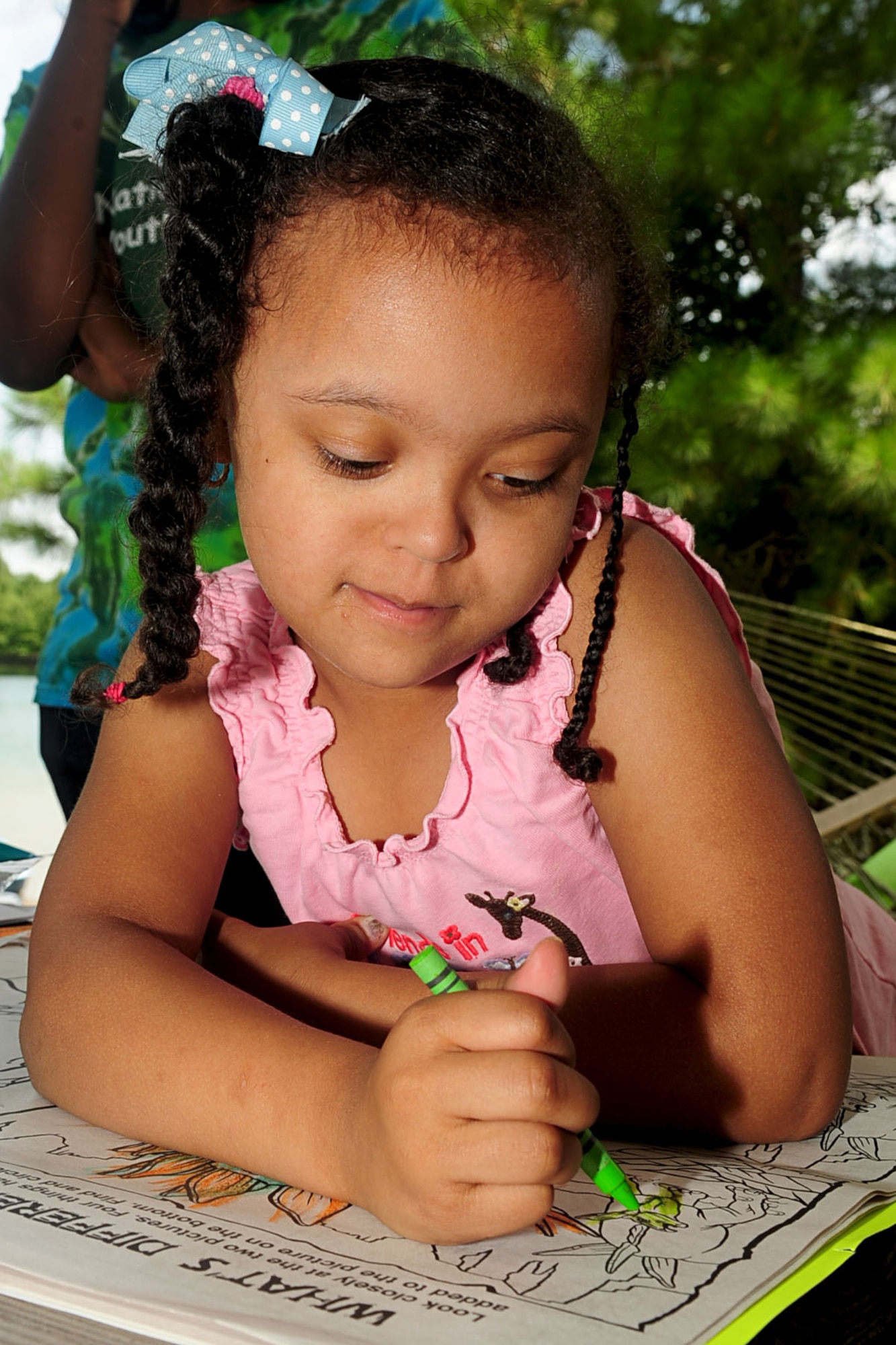 Six-year old Aaliyah Guadalupe, daughter of U.S. Army Capt. Caren Guadalupe, colors during the Wounded Warrior Adaptive sports day at Smithfield, Va., Aug. 23, 2012. The day included a lunch and dinner cookout, as well as information from sports and disability resource organizations for wounded warriors and their dependents. (U.S. Air Force photo by Staff Sgt. Ashley Hawkins/Released)
