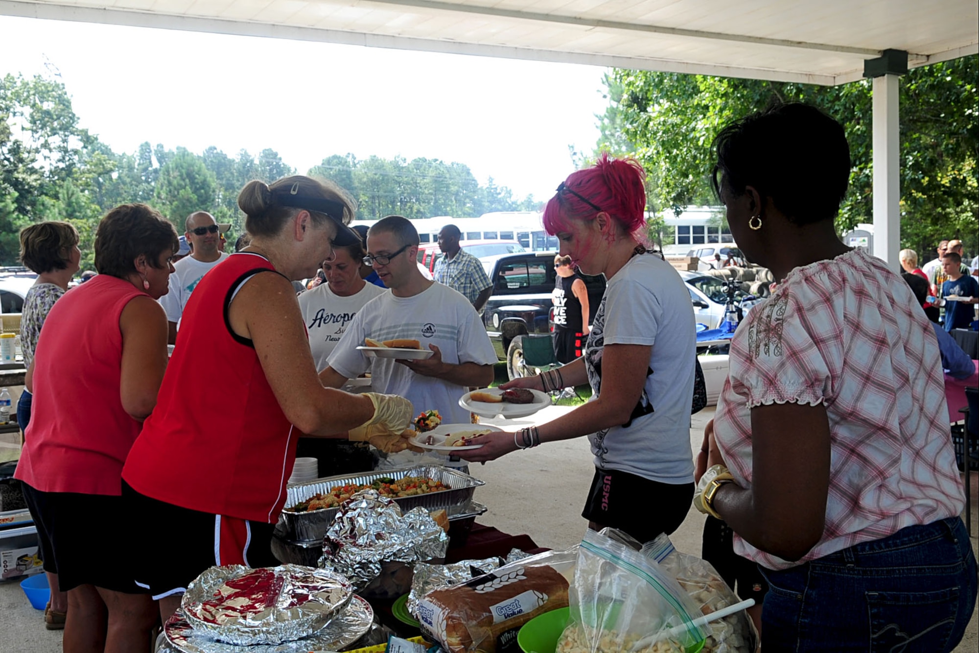 Volunteers serve lunch to Service members and their dependents during the Wounded Warrior Adaptive sports day at Smithfield, Va., Aug. 23, 2012. The event was held to encourage sportsmanship and provide sporting opportunities for Service members with disabilities. (U.S. Air Force photo by Staff Sgt. Ashley Hawkins/Released)