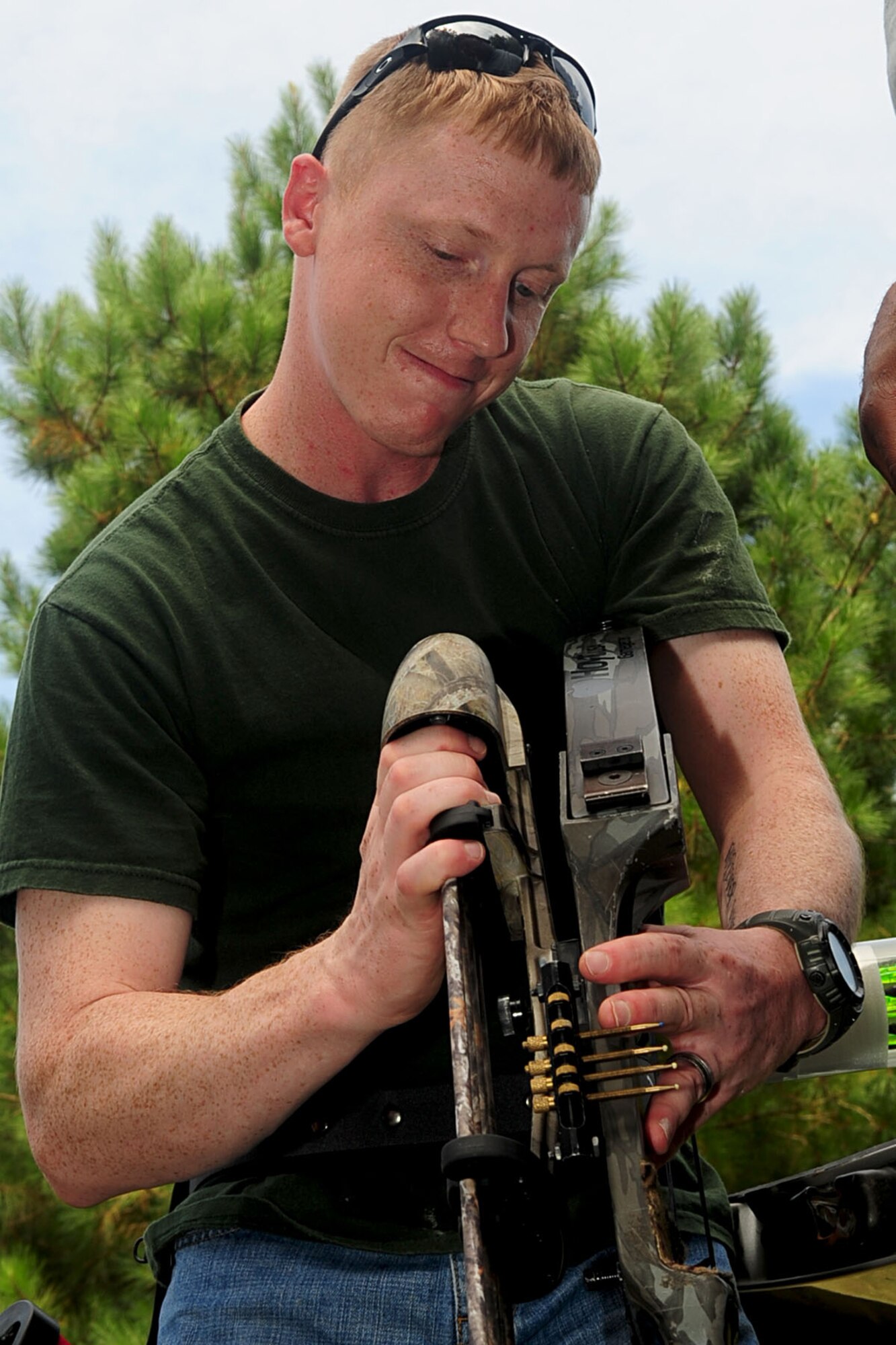 U.S. Army Sgt. James Algood, an archery instructor assigned to Fort Eustis' Warrior Transition Unit, adjusts the quiver on a bow during the assisted bow-and-arrow portion of the Wounded Warrior Adaptive sports day at Smithfield, Va., Aug. 23, 2012. The Virginia Community-Based Warrior Transition Unit provides various adaptive sporting events for Service members with disabilities. (U.S. Air Force photo by Staff Sgt. Ashley Hawkins/Released)