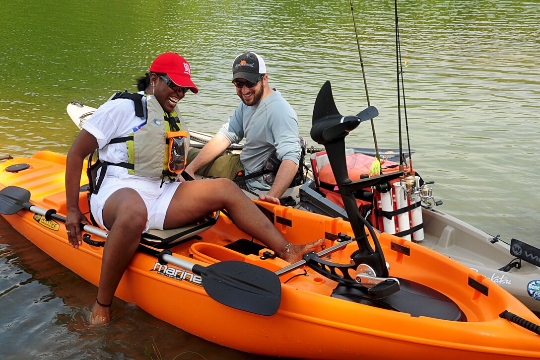 Matt Anderson, a volunteer with Heroes on the Water, helps U.S. Army Maj. Donna Rowell into a kayak during the assisted kayaking portion of Wounded Warrior Adaptive sports day in Smithfield, Va., Aug. 23, 2012. Wounded warriors from Virginia and surrounding states enjoyed a variety of outdoor sports including stand up-sit down paddle boarding and Tai Chi. (U.S. Air Force photo by Staff Sgt. Ashley Hawkins/Released)