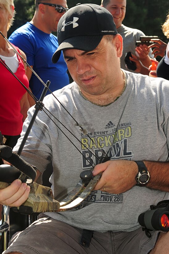 U.S. Army Sgt. Jeremy Bledsoe, a Soldier assigned to the Virginia Community-Based Warrior Transition Unit, examines his bow before the assisted bow-and-arrow event during the Wounded Warrior Adaptive sports day in Smithfield, Va., Aug. 23, 2012. Wounded warriors from Virginia and surrounding states enjoyed a variety of outdoor sports, including archery and kayaking. (U.S. Air Force photo by Staff Sgt. Ashley Hawkins/Released)