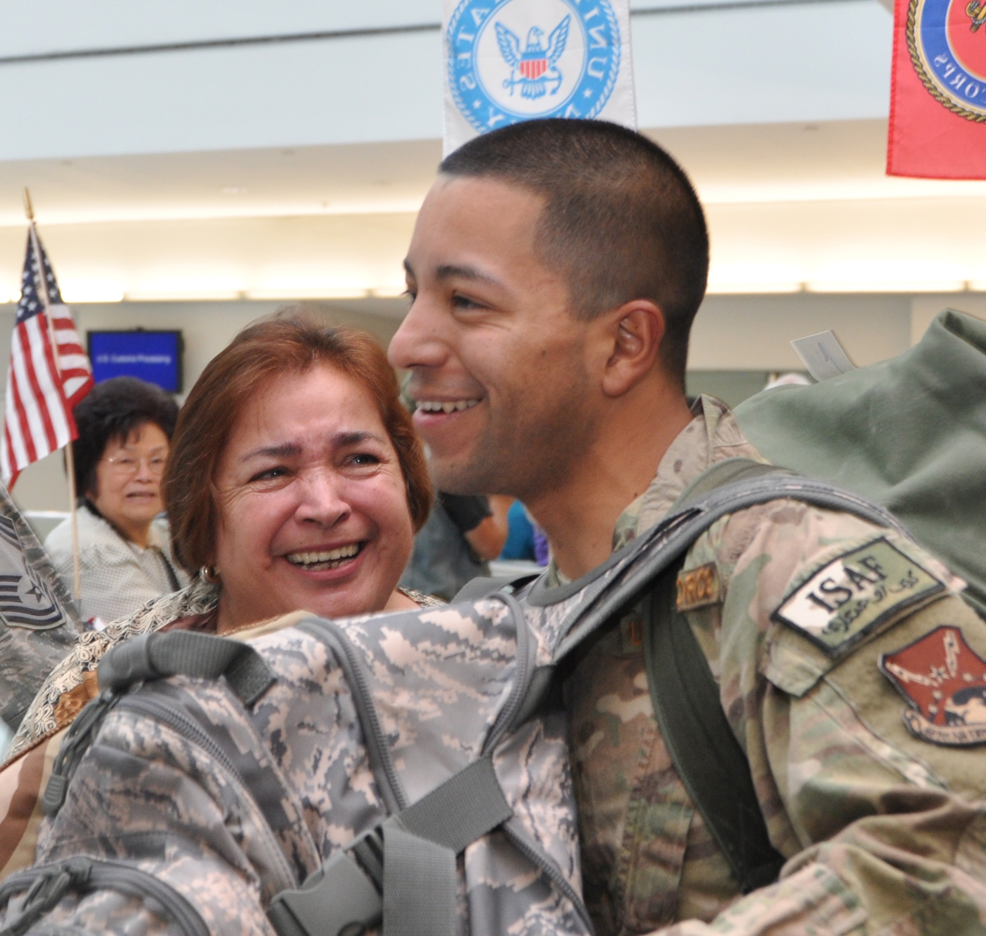 U.S. Air Force Staff Sgt. Diego Yanez, 69th Aerial Port Squadron, smiles as his mother, Martha Yanez, looks at her son as he exits the terminal at Baltimore-Washington International Thurgood Marshall Airport, Md., Aug. 24, 2012. The 69 APS welcomed home 15 troops who were returning from a six-month deployment to Afghanistan. (U.S. Air Force photo/ Senior Airman Katie Spencer)