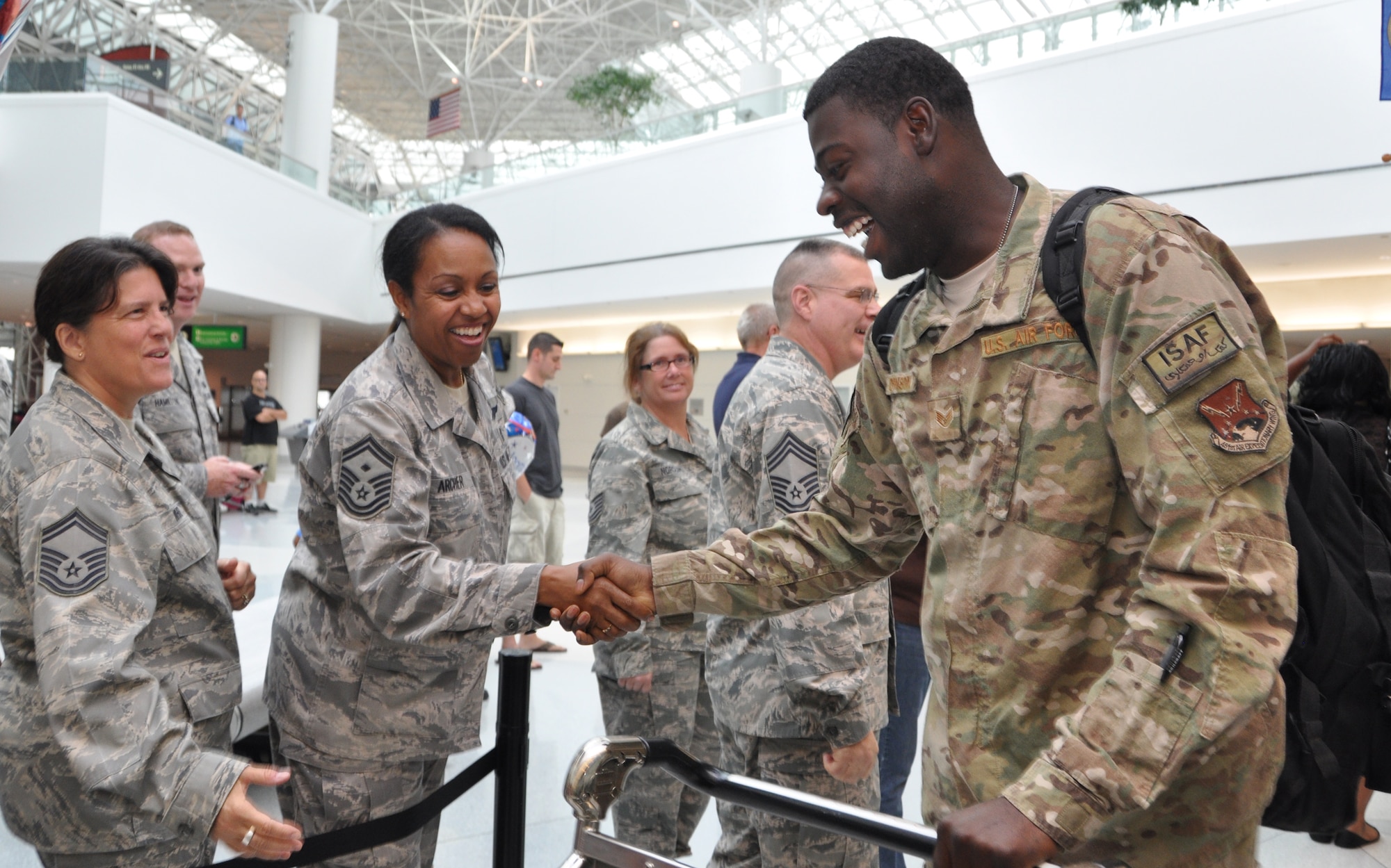 U.S. Air Force Staff Sgt. Carl Johnson, 69th Aerial Port Squadron, shakes the hand of Air Force Senior Master Sgt. Diana Archer, 69 APS first sergeant, at Baltimore-Washington International Thurgood Marshall Airport, Md., Aug. 24, 2012. The 69 APS welcomed home 15 troops who were returning from a six-month deployment to Afghanistan. (U.S. Air Force photo/ Senior Airman Katie Spencer) 