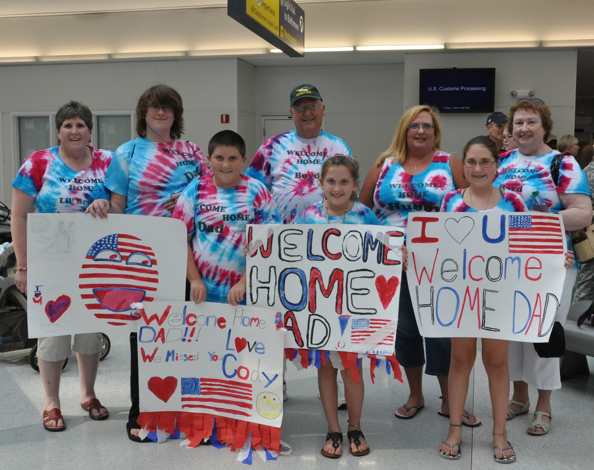 Family members of U.S. Air Force Chief Master Sgt. Boyd Clendenen, 69th Aerial Port Squadron, await his arrival at Baltimore-Washington International Thurgood Marshall Airport, Md., Aug. 24, 2012. The 69 APS welcomed home 15 troops who were returning from a six-month deployment to Afghanistan. (U.S. Air Force photo/ Senior Airman Katie Spencer)