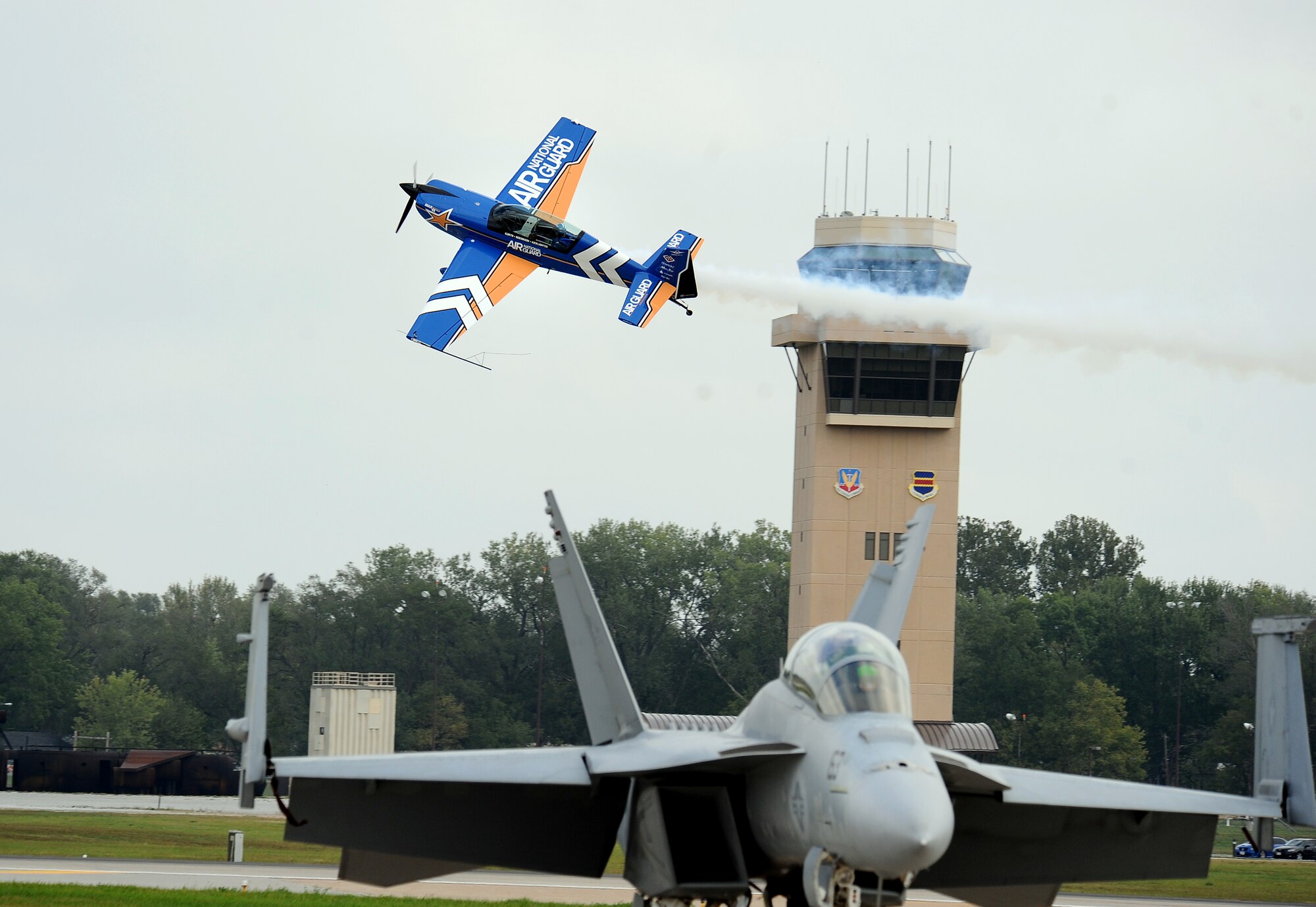 With his Air National Guard MXS all carbon-fiber aircraft, pilot John Klatt (Lt. Col. Retired) screams by show center while performing in the 2012 Defenders of Freedom Open House and Air Show hosted annually by Offutt Air Force Base, Neb., Aug. 26.  (U.S. Air Force Photo by Josh Plueger/Released)