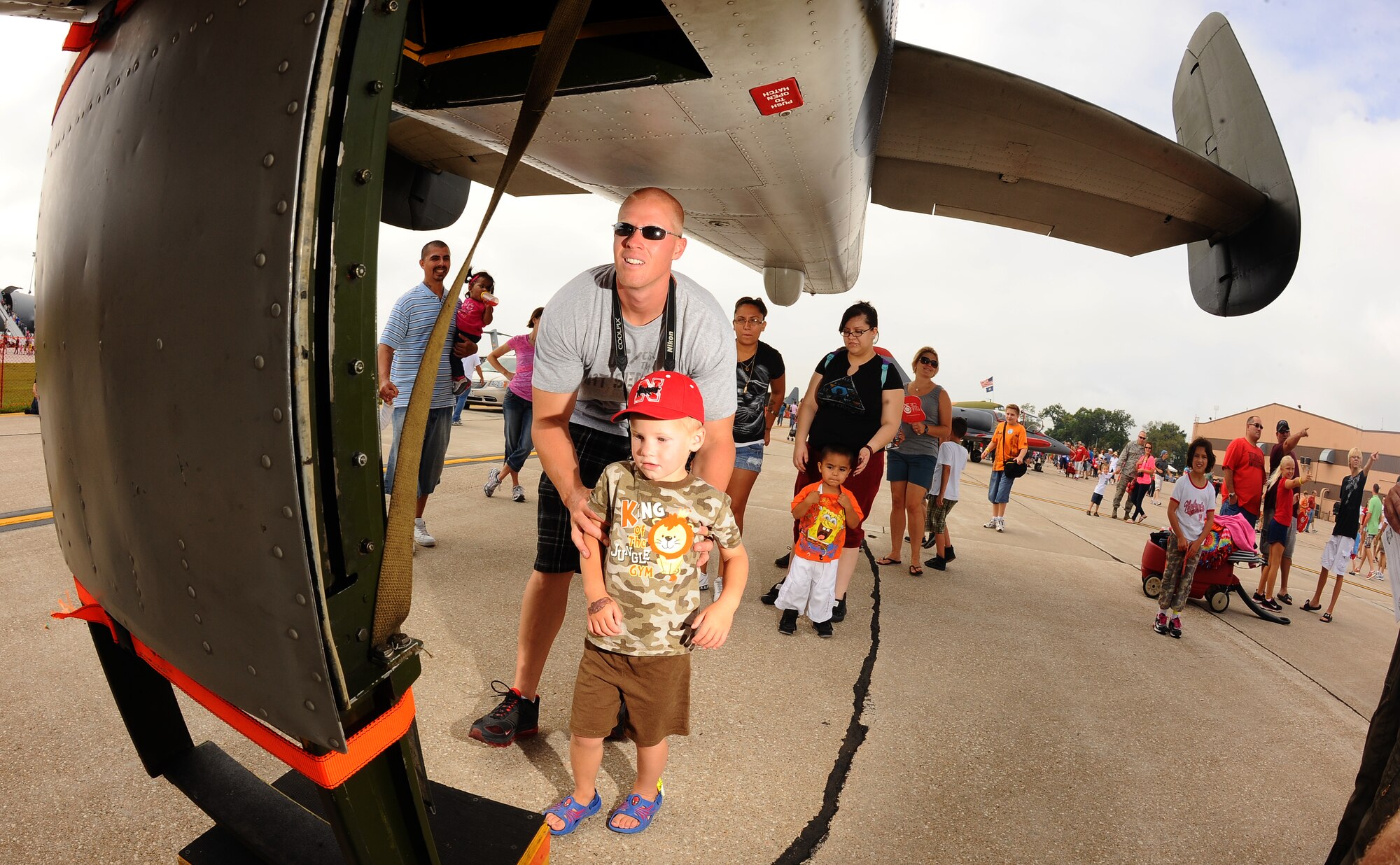 Three-year-old Dreyden Ristine with his father Ramey take a peek into the tail end of a B-25 Mitchell, one of the static displays at the Defenders of Freedom Open House and Air Show hosted by Offutt Air Force Base, Neb., Aug. 26.  The Ristine family drove from Kearney, Neb., to attend the annual show.  (U.S. Air Force Photo by Josh Plueger/Released)