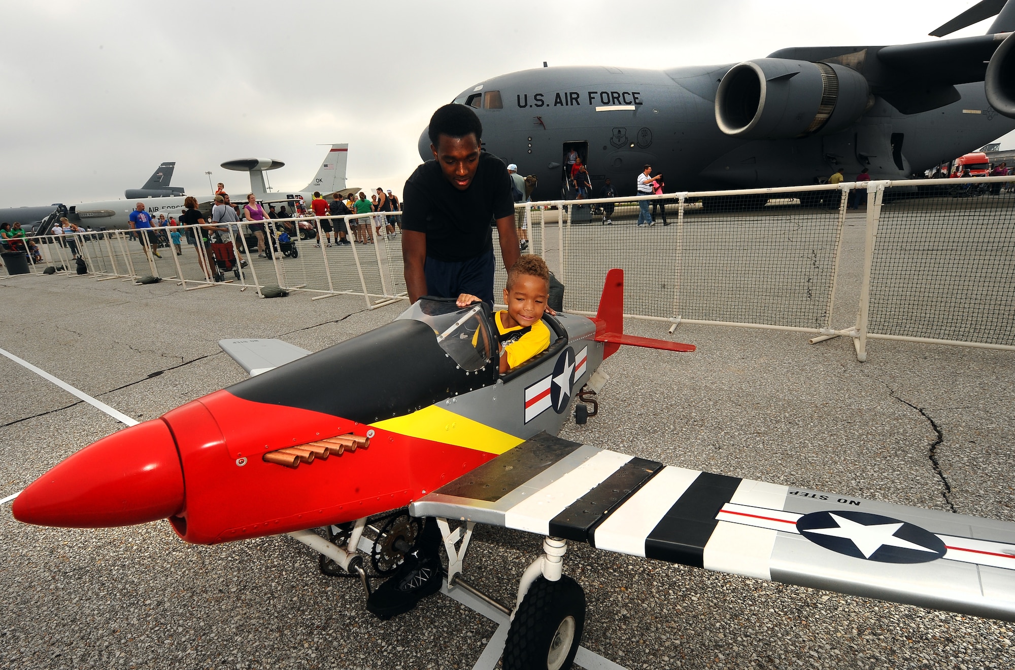 Eight-year-old Davon Greer parks his peddle plane while participating in one of numerous children’s activities held at the 2012 Defenders of Freedom Open House and Air Show held at Offutt Air Force Base, Neb., Aug. 26.  The peddle planes are a popular attraction every year at the Air Show.  (U.S. Air Force Photo by Josh Plueger/Released)