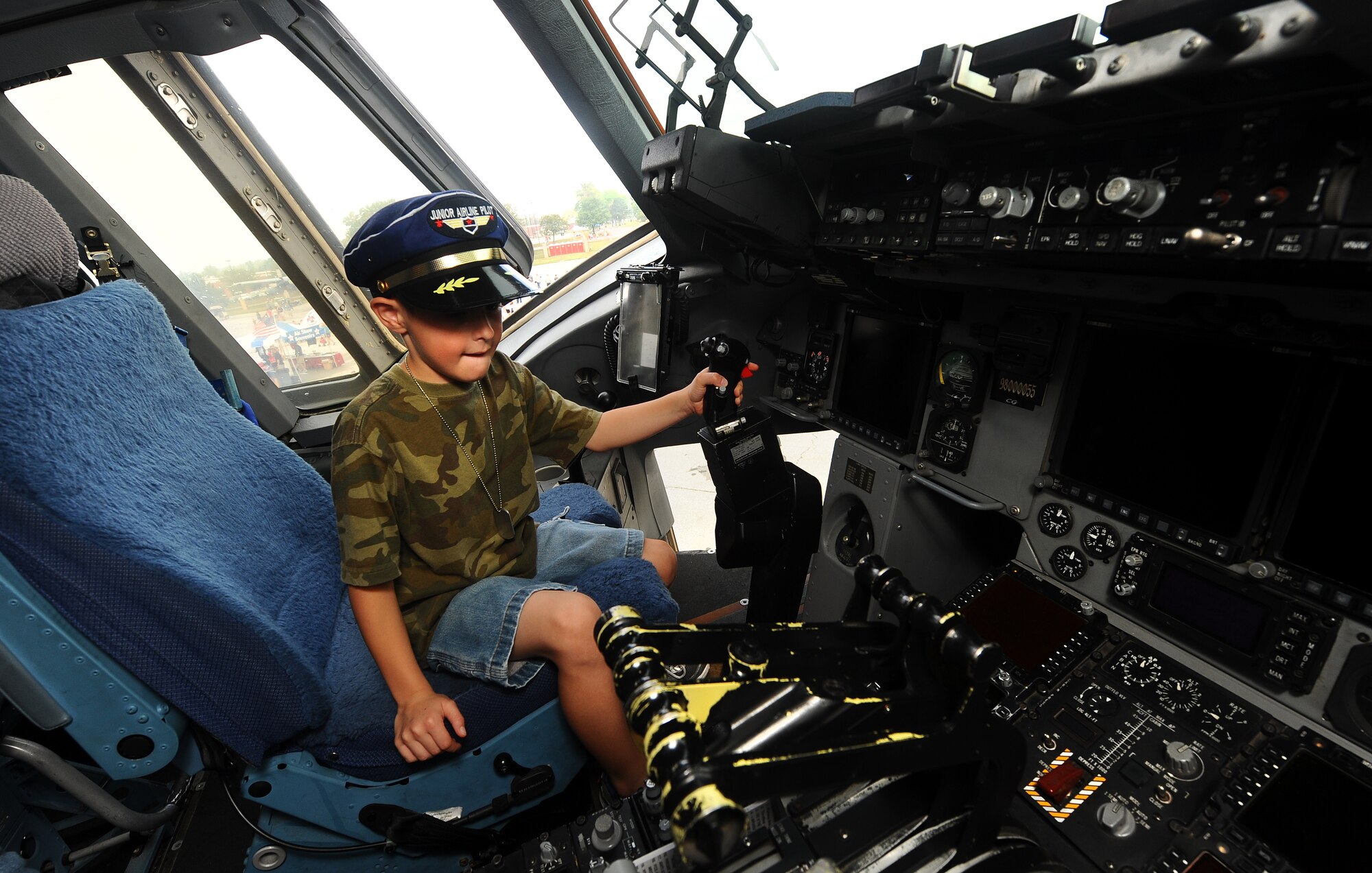 Six-year-old Malcome Chrosniak sits in the cockpit of a C-17 Globemaster while attending the 2012 Defenders of Freedom Open House and Air Show hosted annually by Offutt Air Force Base, Neb., Aug. 26.  The C-17 is the largest of more than 60 static displays.  (U.S. Air Force Photo by Josh Plueger/Released)