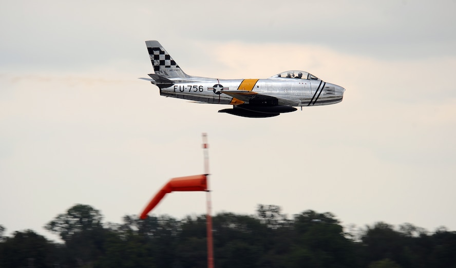 An F-86 Sabre flies by the flight tower at Offutt Air Force Base, Neb., Aug. 24.  Friday’s Air Show is designated as the Special Needs Air Show where kids with special needs get a front row show and meet with pilots and commanders.  (U.S. Air Force Photo by Josh Plueger/Released)