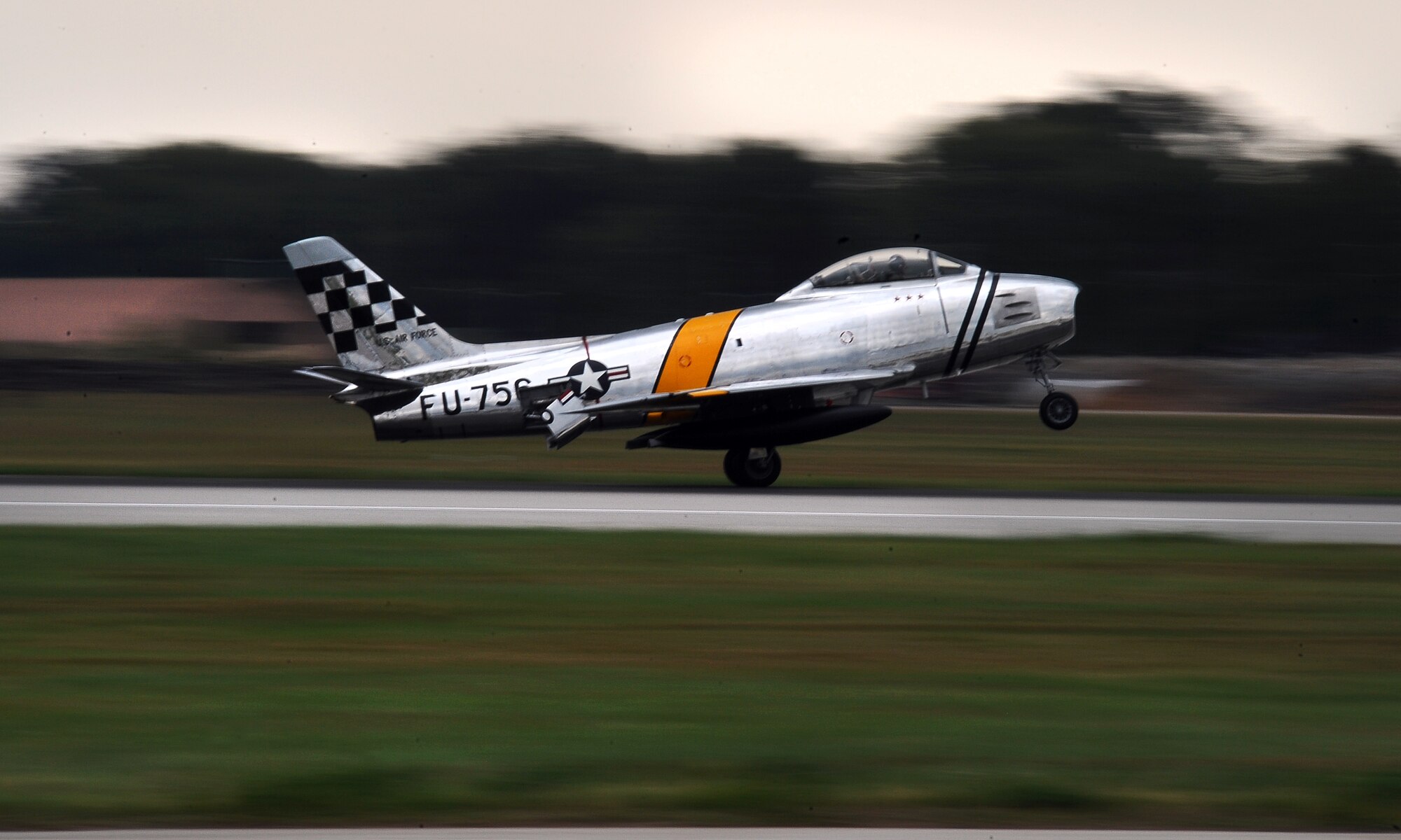 An F-86 Sabre touches down on the Offutt Air Force Base, Neb., flight line following a heritage flight during the practice air show held Aug. 24.  Children with special needs, Make-A-Wish participants and Wounded Warriors get exclusive access to both the aircraft and pilots the day before the Defenders of Freedom Air Show begins.  (U.S. Air Force Photo by Josh Plueger/Released)